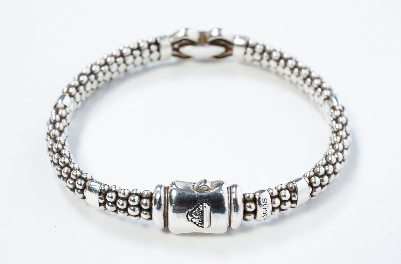 LAGOS CAVIAR STERLING SILVER DIAMOND BRACELET.: LAGOS CAVIAR STERLING SILVER DIAMOND BRACELET. American, contemporary. Caviar bracelet with a tab clasp, and with a horsebit-style accent set with eleven diamonds. Hallmarked to band and clasp. 6.5"