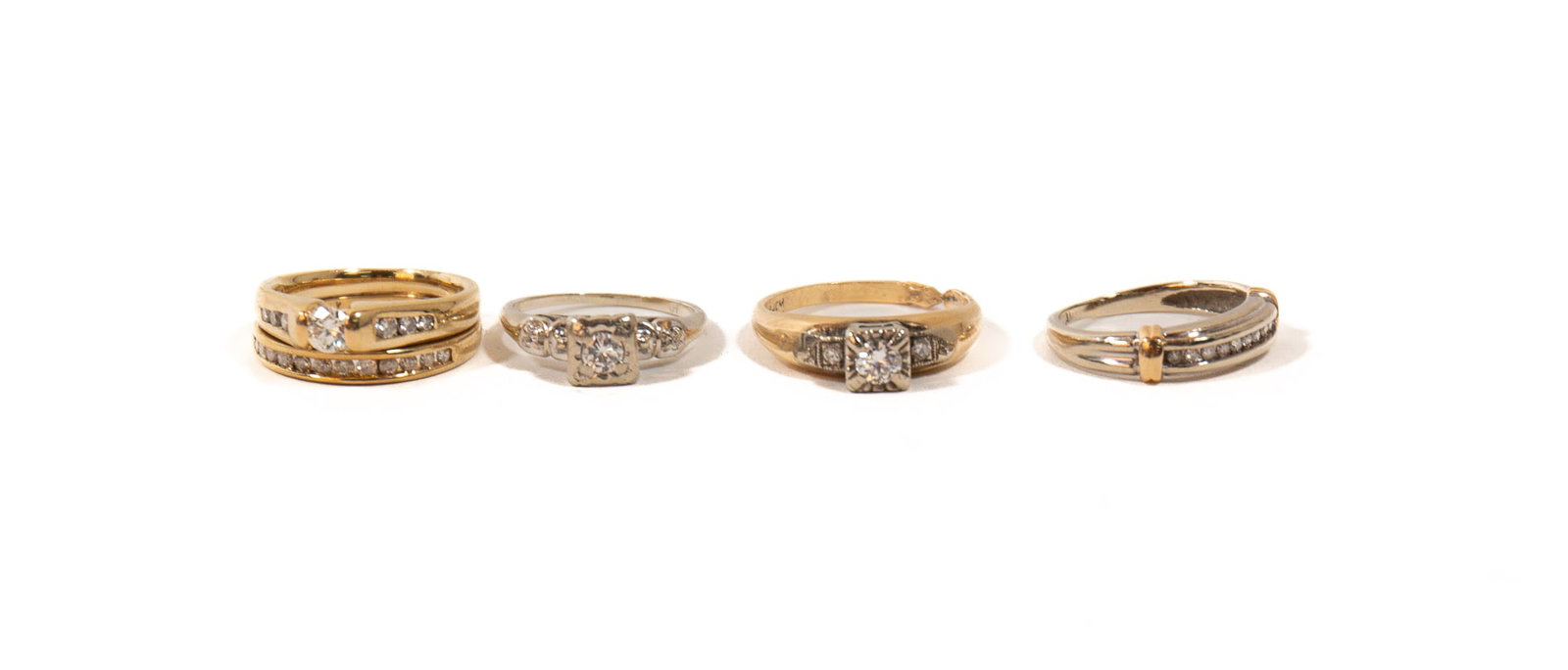 FOUR 14K GOLD AND DIAMOND RINGS.: FOUR 14K GOLD AND DIAMOND RINGS. Contemporary. A 14k yellow gold soldered engagement ring and wedding band set, with a tension-set round brilliant-cut diamond, H/SI1, 0.25ct., surrounded by six