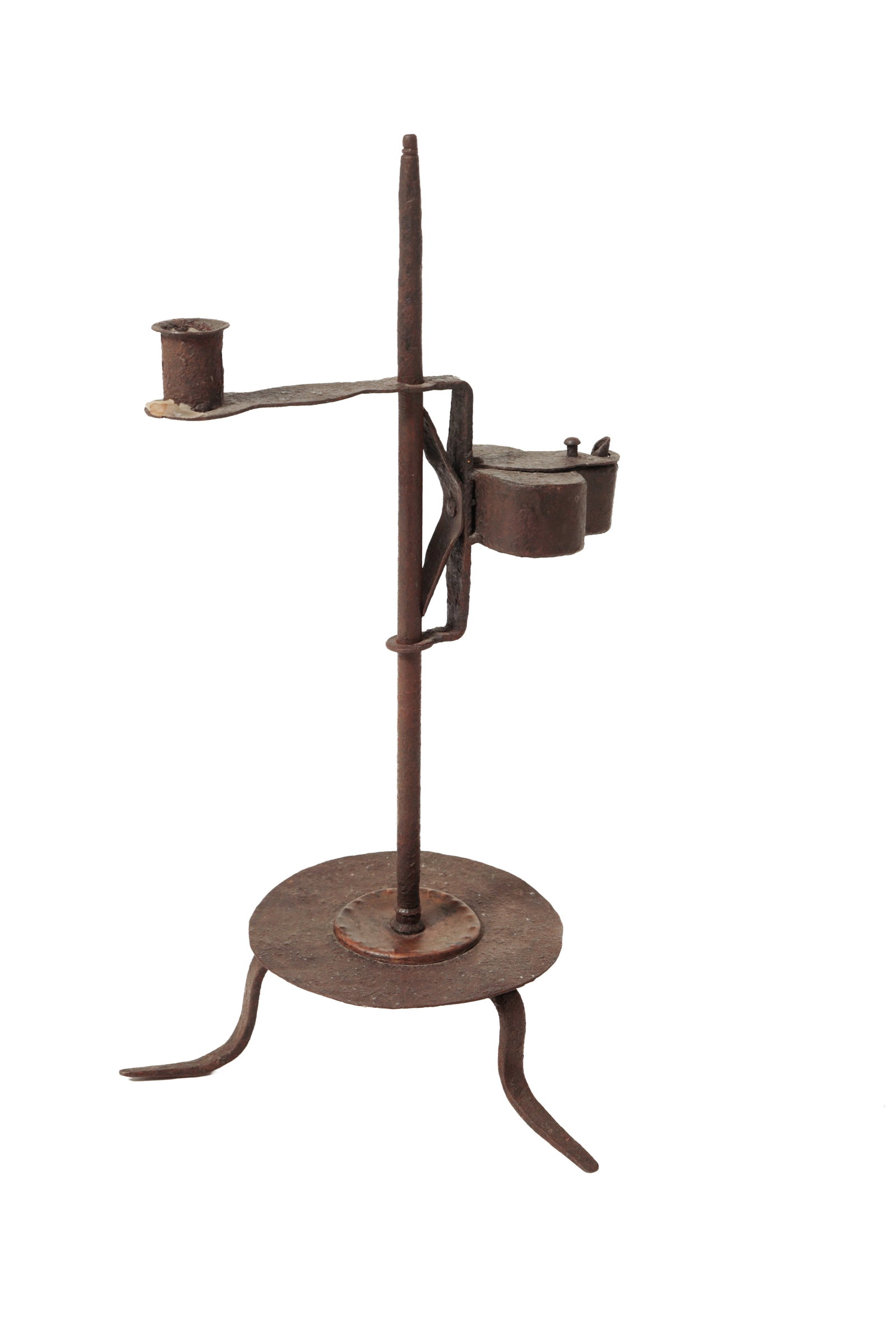 WROUGHT IRON ADJUSTABLE TABLETOP GREASE LAMP CANDLESTICK.: WROUGHT IRON ADJUSTABLE TABLETOP GREASE LAMP CANDLESTICK. American, 19th Century. Spring-adjusted candle holder with shaped grease lamp. On circular base with a copper accent raised on three curved