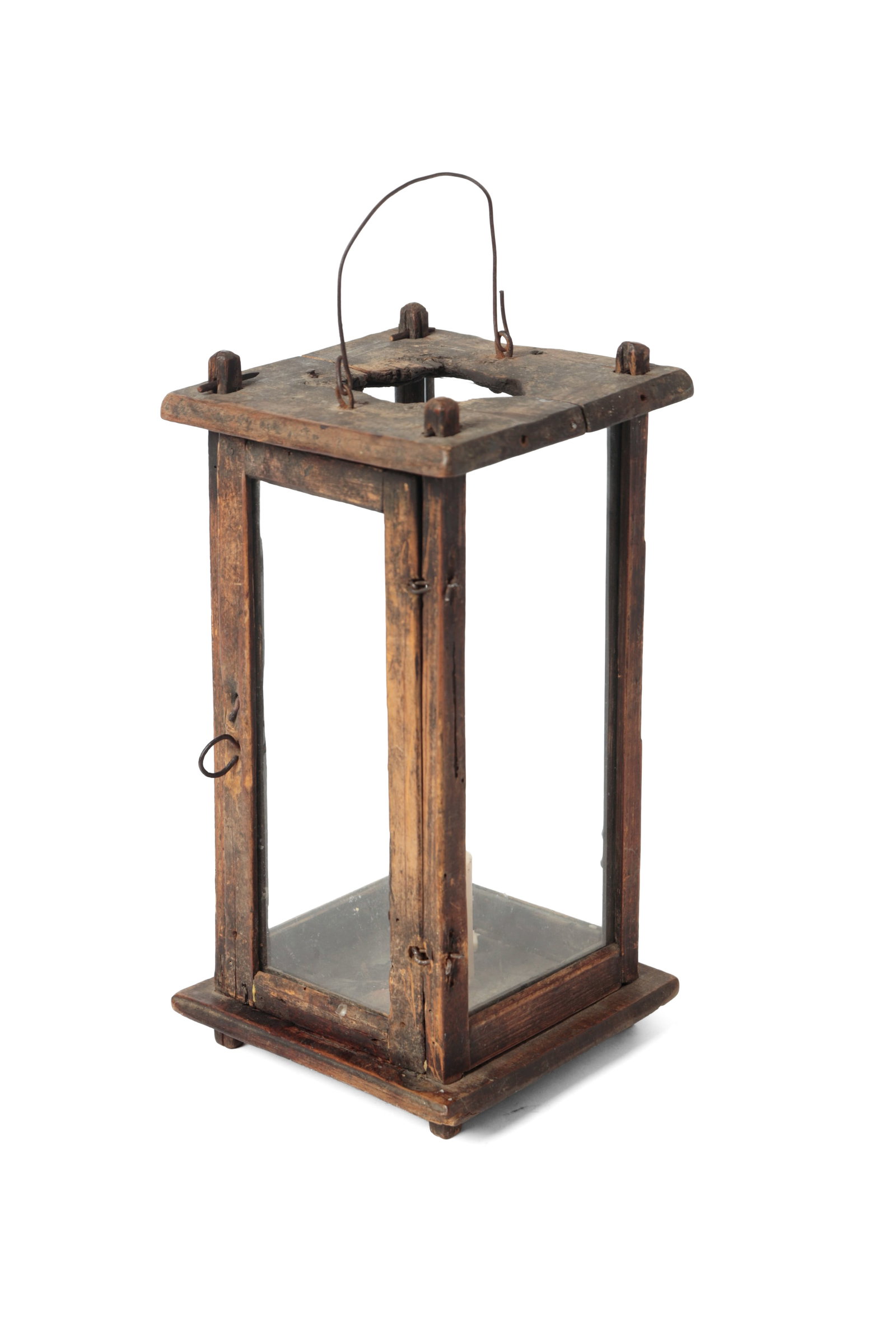 PINE BARN LANTERN.: PINE BARN LANTERN. American, mid- 19th Century. Wire bale handle, pegged frame, four glass panels, door with snipe hinges, and spike candle socket, raised on four feet. 11.5"h. 6"w. 5.75"d.