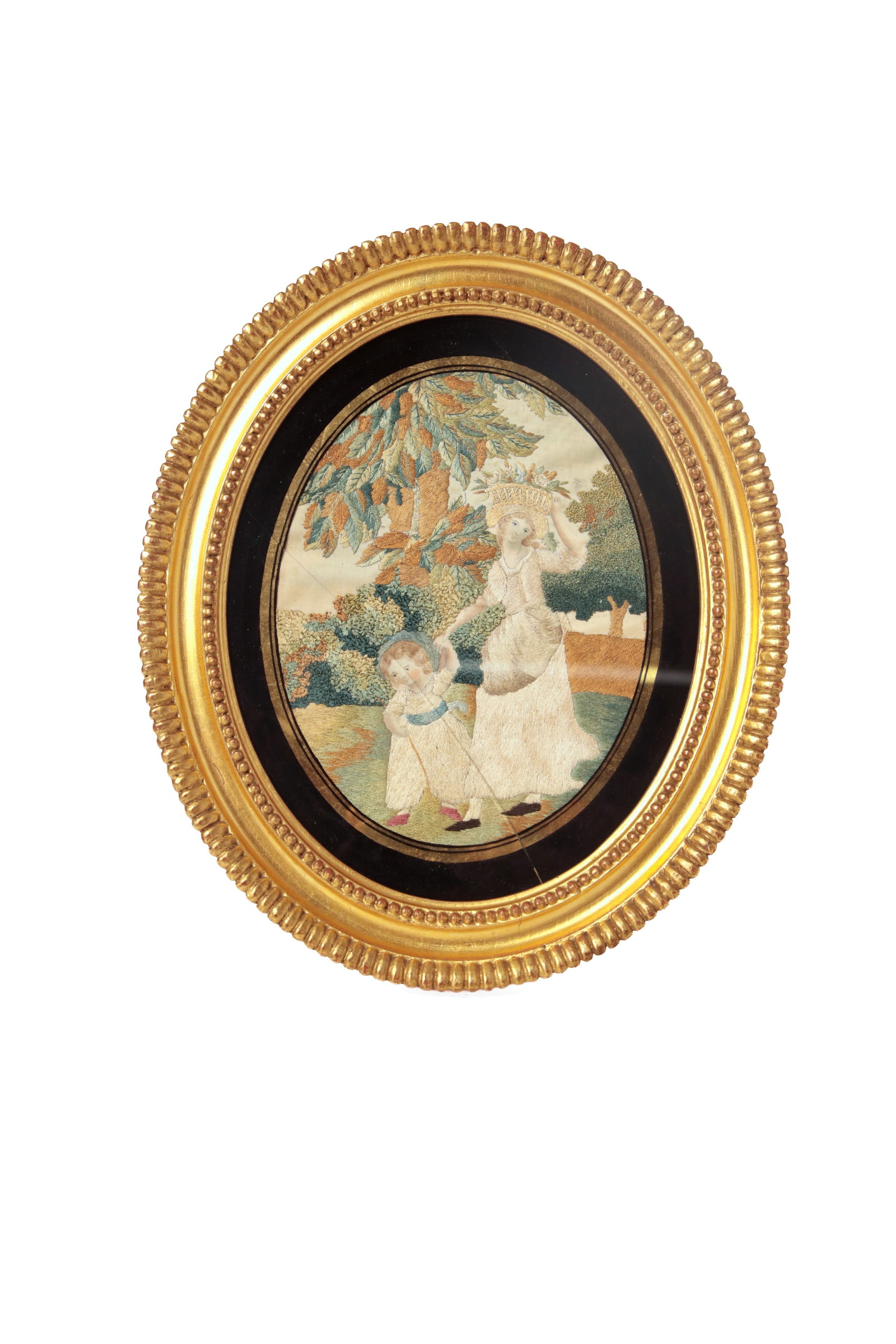 SILK STUMPWORK EMBROIDERY SCENE OF A MOTHER AND HER CHILD IN A LUSH PASTORAL LANDSCAPE.: SILK STUMPWORK EMBROIDERY SCENE OF A MOTHER AND HER CHILD IN A LUSH PASTORAL LANDSCAPE. English, mid- 19th Century. Depicting a woman and child walking and holding hands, the woman carrying a basket