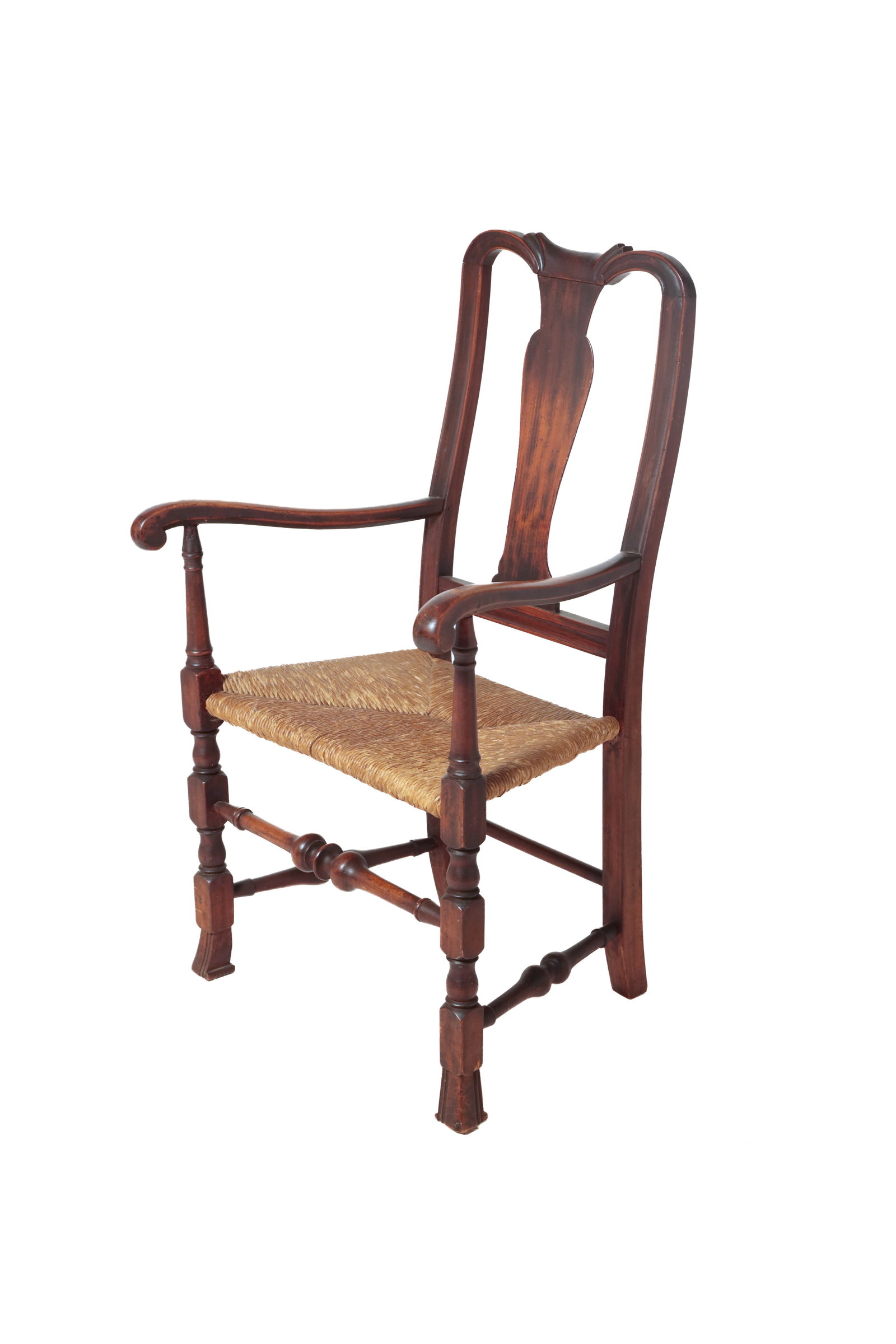 RHODE ISLAND QUEEN ANNE SPANISH FOOT ARMCHAIR.: RHODE ISLAND QUEEN ANNE SPANISH FOOT ARMCHAIR. American, mid- 18th Century. Having bold Baroque turnings, carved crest rail, scrolled arms, Spanish feet at the front, and a rush seat. Maintained old f