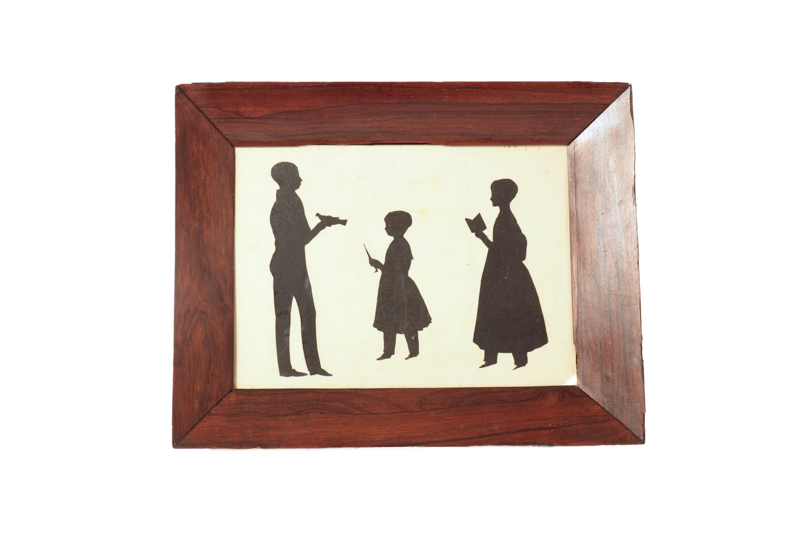 CUT PAPER FULL-LENGTH SILHOUETTE TABLEAU PORTRAIT OF THREE CHILDREN.: CUT PAPER FULL-LENGTH SILHOUETTE TABLEAU PORTRAIT OF THREE CHILDREN. American or English, 19th Century. The young man with bird in hand faces two young ladies, one holding a toy parasol and the other