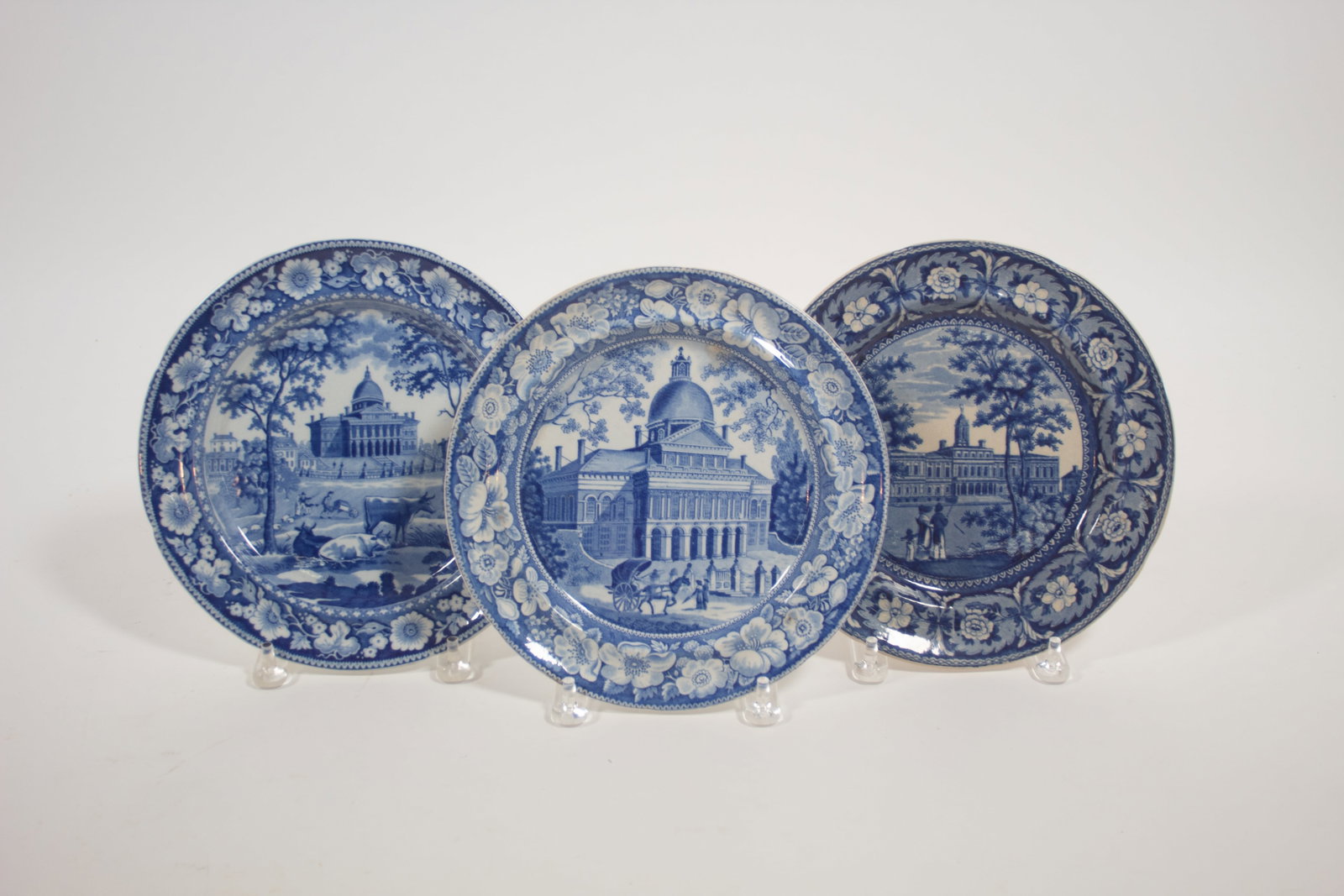 THREE HISTORICAL BLUE STAFFORDSHIRE PLATES WITH AMERICAN SCENES.: THREE HISTORICAL BLUE STAFFORDSHIRE PLATES WITH AMERICAN SCENES. English, 19th Century. Rogers plate with Massachusetts state house in Boston, impressed mark on reverse. 10"d. Enoch Wood & Sons plate