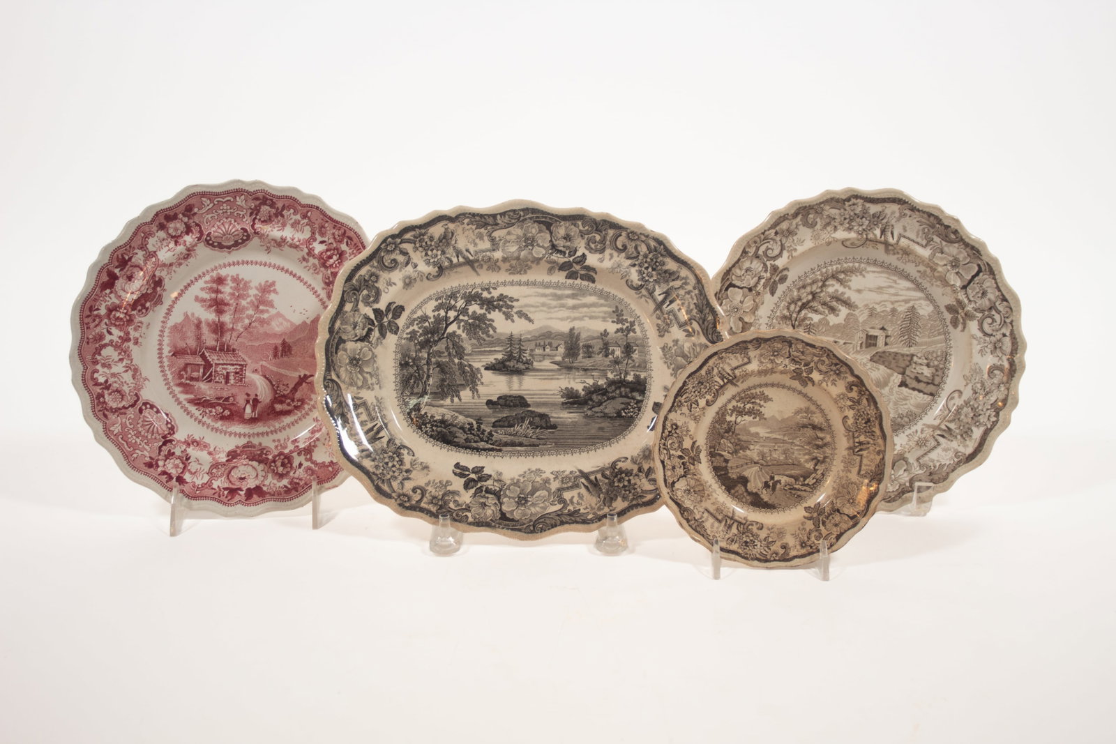 STAFFORDSHIRE HISTORICAL AMERICAN SCENES TRANSFERWARE.: STAFFORDSHIRE HISTORICAL AMERICAN SCENES TRANSFERWARE. English, 19th Century. Featuring a Clews platter in black transfer of "Picturesque Views near Fort Miller, Hudson River", 10.75"w., two plates in
