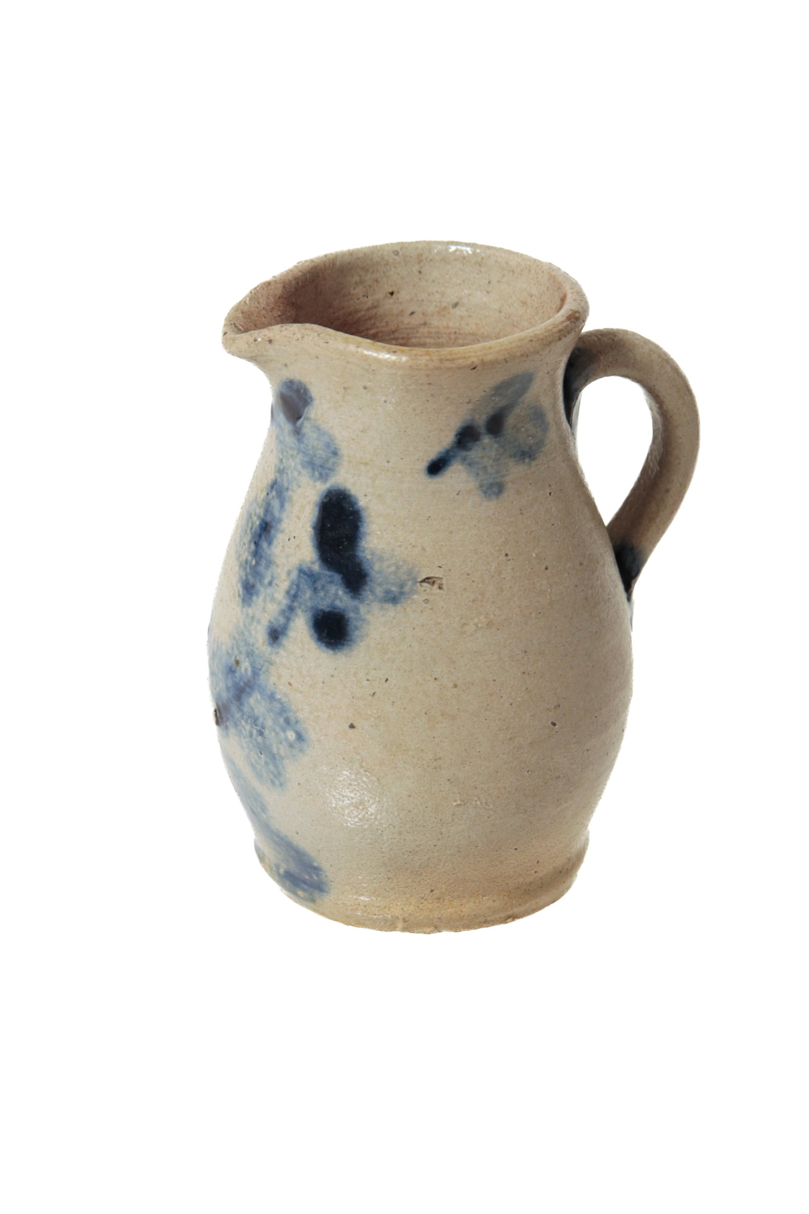 MINIATURE COBALT-DECORATED STONEWARE PITCHER.: MINIATURE COBALT-DECORATED STONEWARE PITCHER. American, 19th Century. Semi-ovoid body, flared rim, small spout, and applied handle. With a cobalt pot of flowers decoration. 3.5"h. Provenance: Nancy Go