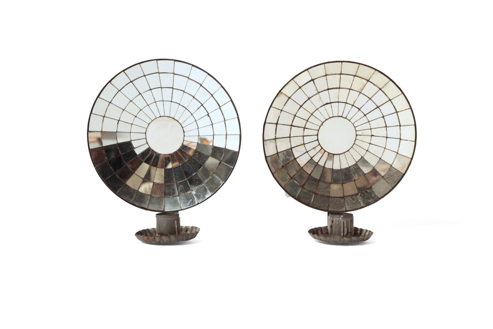PAIR OF MIRROR-BACKED CANDLE SCONCES.: PAIR OF MIRROR-BACKED CANDLE SCONCES. American, mid- 19th Century. Tinned sheet metal backs, "L" shaped brackets, crimped bobeche, and mosaiced mirrored backs. 9"h. 7.75"w. 5"d.