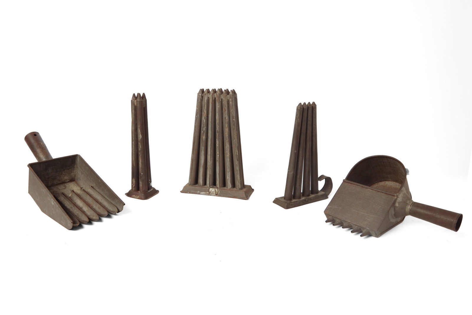 THREE CANDLE MOLDS AND TWO MOLD FILLERS.: THREE CANDLE MOLDS AND TWO MOLD FILLERS. American, 19th Century. Two four tube molds, 7"w. 10"l. and 3"w. 10.25"l., a twelve-tube mold, 7.5"w. 11"l., a five-fingered filler, 5.25"w. 14"l., and a five-