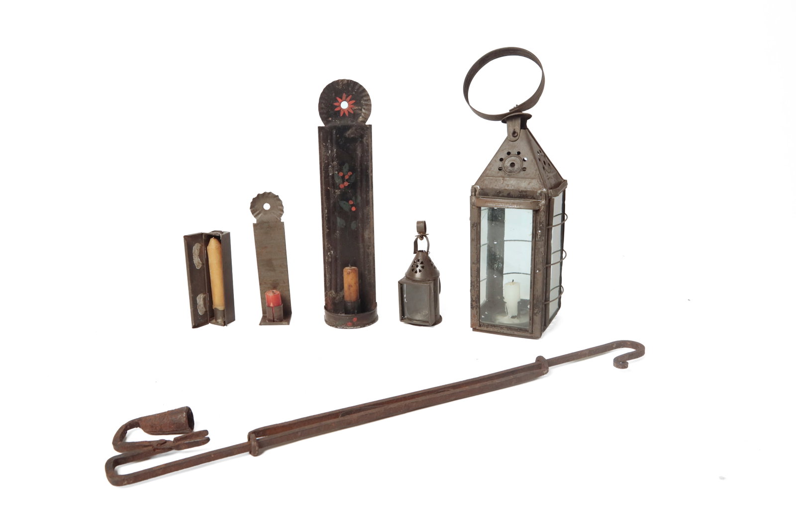 GROUP OF EARLY LIGHTING.: GROUP OF EARLY LIGHTING. American, 19th Century. A hanging wrought iron spring-loaded rush light with candleholder, 25.5"l., a tinned metal and glass candle lantern with iron guards, pyramid top, and