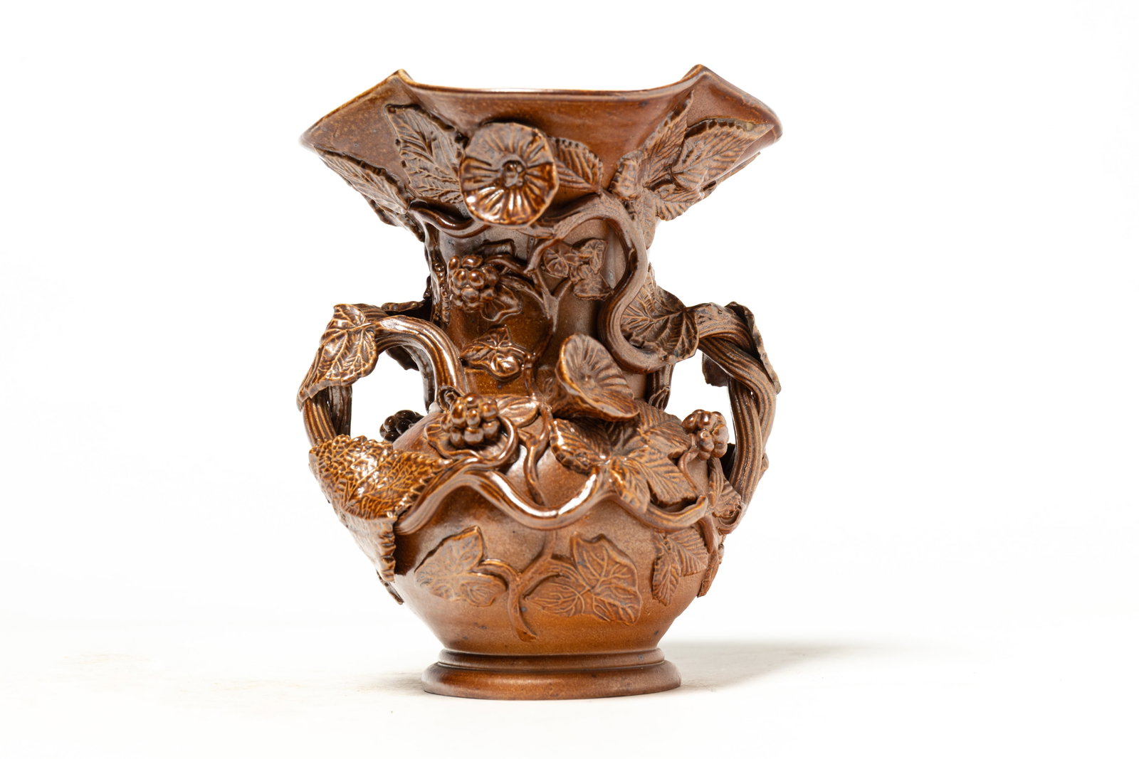 UNUSUAL BUFF CLAY HIGHLY DECORATED HANDLED VASE.: UNUSUAL BUFF CLAY HIGHLY DECORATED HANDLED VASE. American (likely Ohio), late 19th or early 20th Century. Vase form with flared scalloped rim, decorated throughout with hand-molded applied vines,