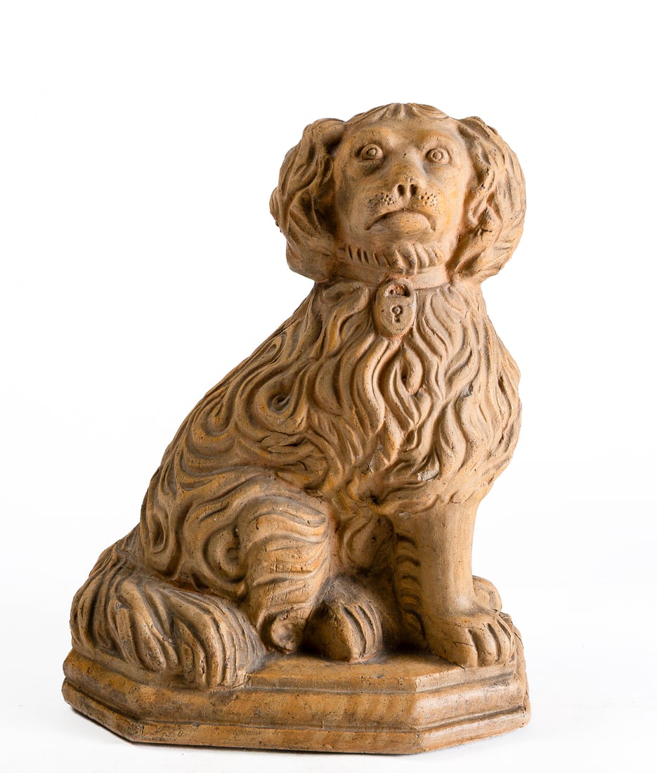 OHIO BUFF CLAY SEATED SPANIEL.: OHIO BUFF CLAY SEATED SPANIEL. American (possibly Uhrichsville, Ohio), late 19th Century. Seated long-haired spaniel with nice detailing, collar with a lock, large bushy tail, and atop a stepped octag