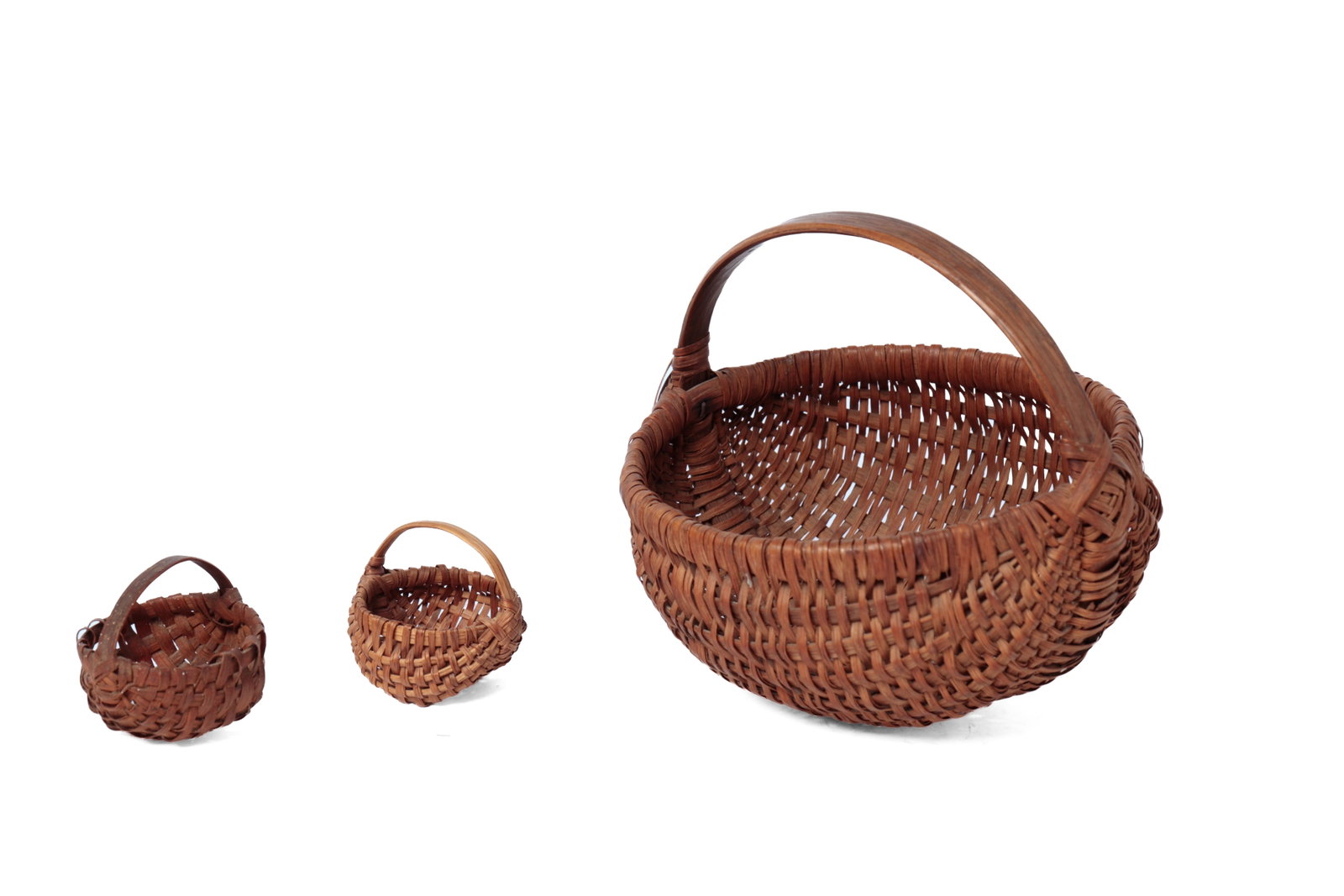THREE DIMINUTIVE AND MINIATURE BASKETS.: THREE DIMINUTIVE AND MINIATURE BASKETS. American, 19th or 20th Century. The larger: a diminutive melon-form basket with a bentwood handle and square nails, 6â€h.