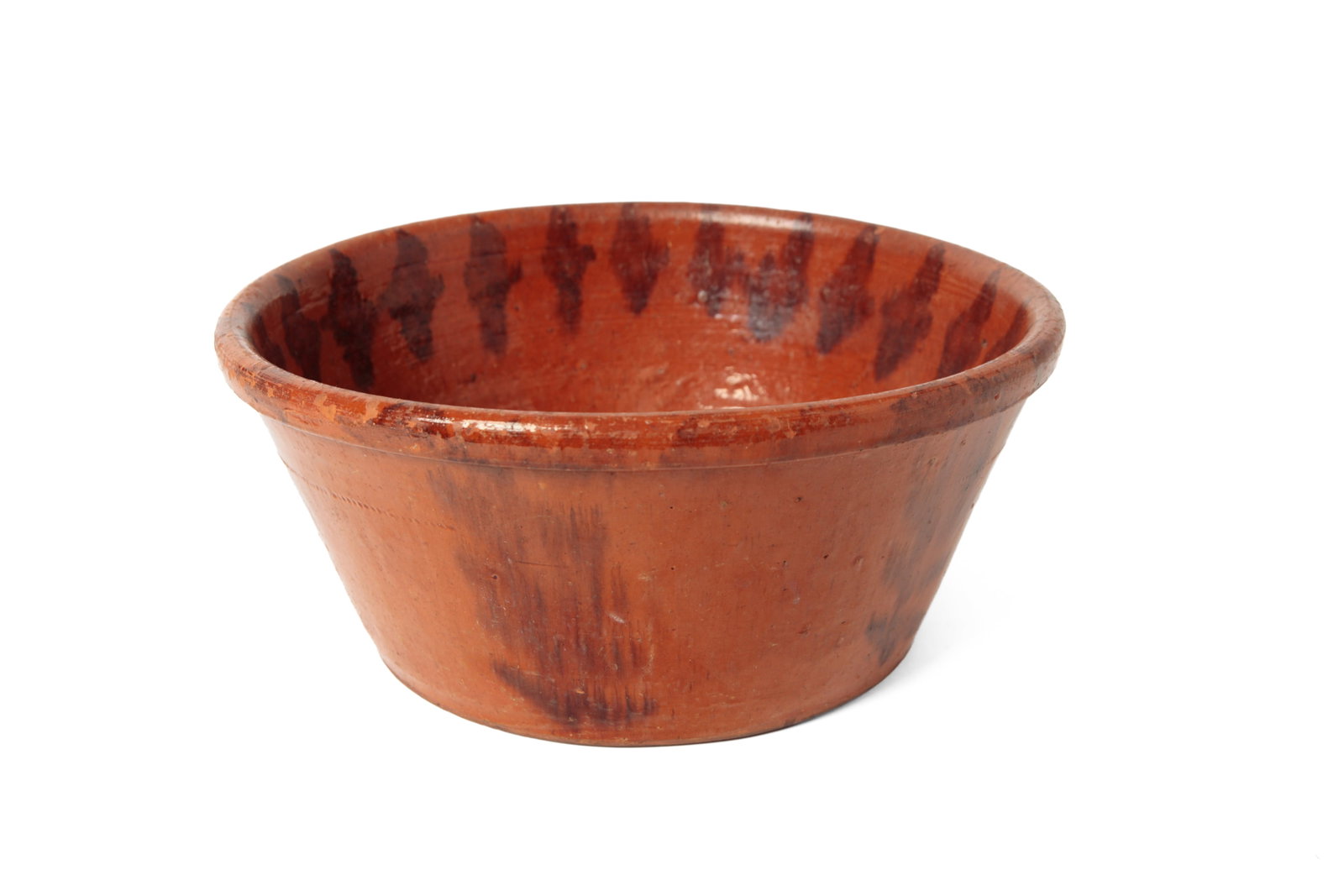 LARGE GLAZED REDWARE BOWL.: LARGE GLAZED REDWARE BOWL. American, 19th Century. Large bowl with canted sides, rolled rim, and coggled band below rim, in an allover orange glaze with manganese sponge decoration. 6"h. 12.75"d.