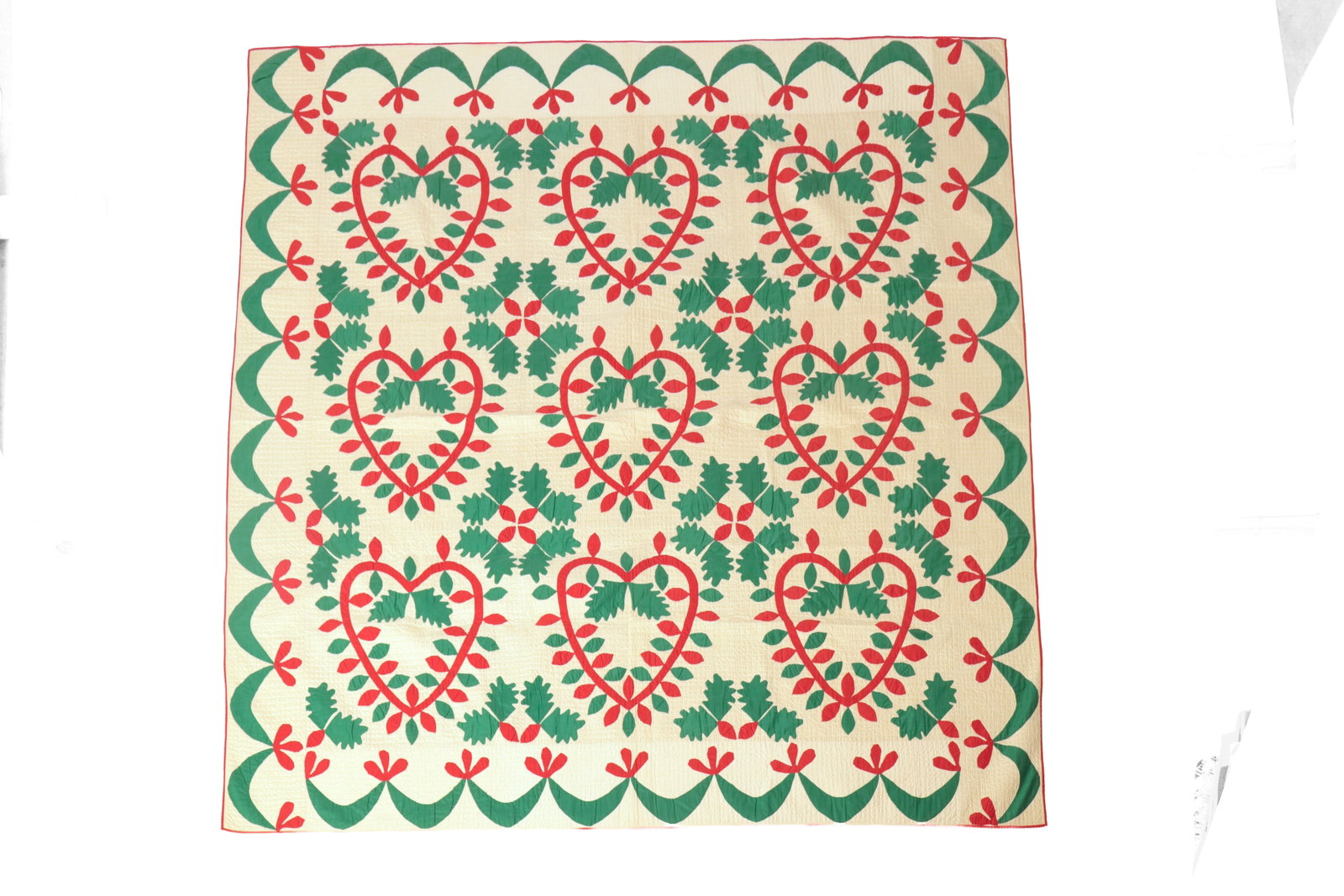 PENNSYLVANIA HAND-STITCHED APPLIQUE QUILT.: PENNSYLVANIA HAND-STITCHED APPLIQUE QUILT. American, late 19th or early 20th Century. Cotton. White ground with wonderful red and green oak leaf and heart motifs, and red edge binding. Likely unwashed