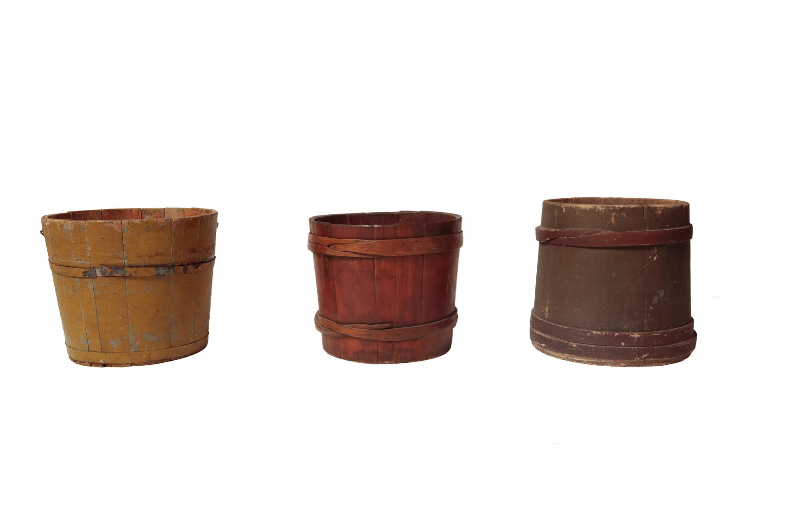 THREE STAVED BUCKETS.: THREE STAVED BUCKETS. American, 19th Century. Mustard over gray painted bucket with bail handle and metal bands. 11.5"h. 13.5"d. Green over blue painted bucket with red-painted with blind notch lap