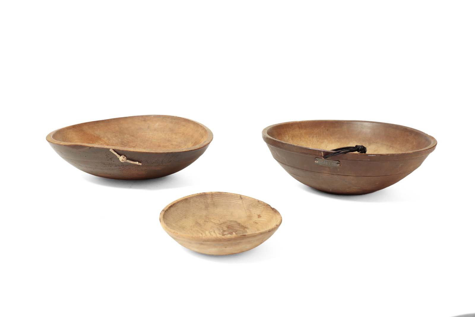 TWO LARGE TURNED BOWLS AND A SMALLER TURNED BOWL WITH ORIGINAL SURFACES.: TWO LARGE TURNED BOWLS AND A SMALLER TURNED BOWL WITH ORIGINAL SURFACES. American, 19th Century. One pine with a wide collar rim, original surface, and hanging hole with cord. 4.5"h. 16.5 to 16.75"d.