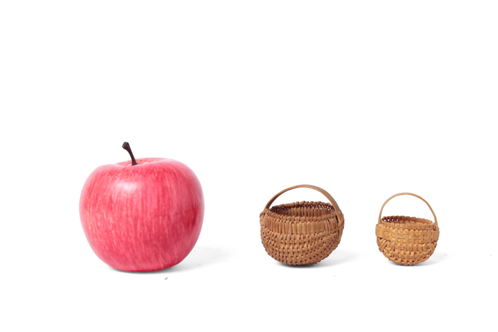 TWO MINIATURE WOVEN SPLIT BUTTOCKS BASKETS.: TWO MINIATURE WOVEN SPLIT BUTTOCKS BASKETS. American, 19th Century. Both with tight weaving and bentwood handles. 1.75”h. 1.5”w. and 1.75”h. 2”w. Provenance: Nancy Goff