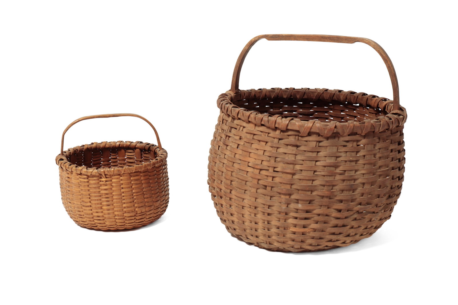TWO DEMI-JOHN BOTTOM HANDLED BASKETS.: TWO DEMI-JOHN BOTTOM HANDLED BASKETS. American, 19th Century. Woven splint baskets in cylindrical form, peaked demi-john bottoms, and stationary bentwood handles. 13.5”h. 13”w. and