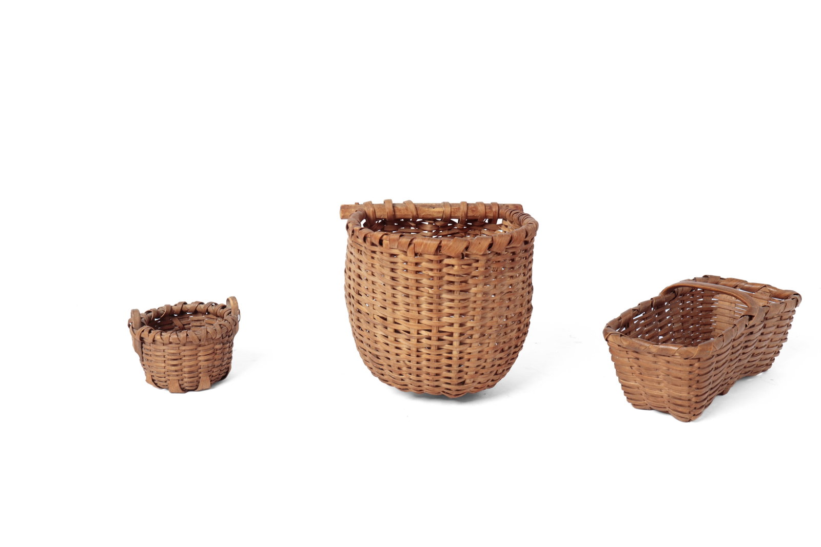 THREE UNUSUAL FORM BASKETS.: THREE UNUSUAL FORM BASKETS. American, 19th or early 20th Century. A round bottom wall hanging basket with woven splints, wrapped rim, and carved stick to back, 7.5”h. 8”w.; a rectangular