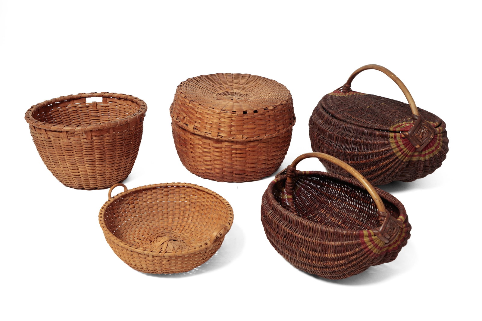 FIVE BASKETS.: FIVE BASKETS. American, 19th and 20th Century. Two are made of vines and have red and green wire decoration at handles, a picnic basket, 14.5"h., and a buttocks basket, 10"h., and three are oak