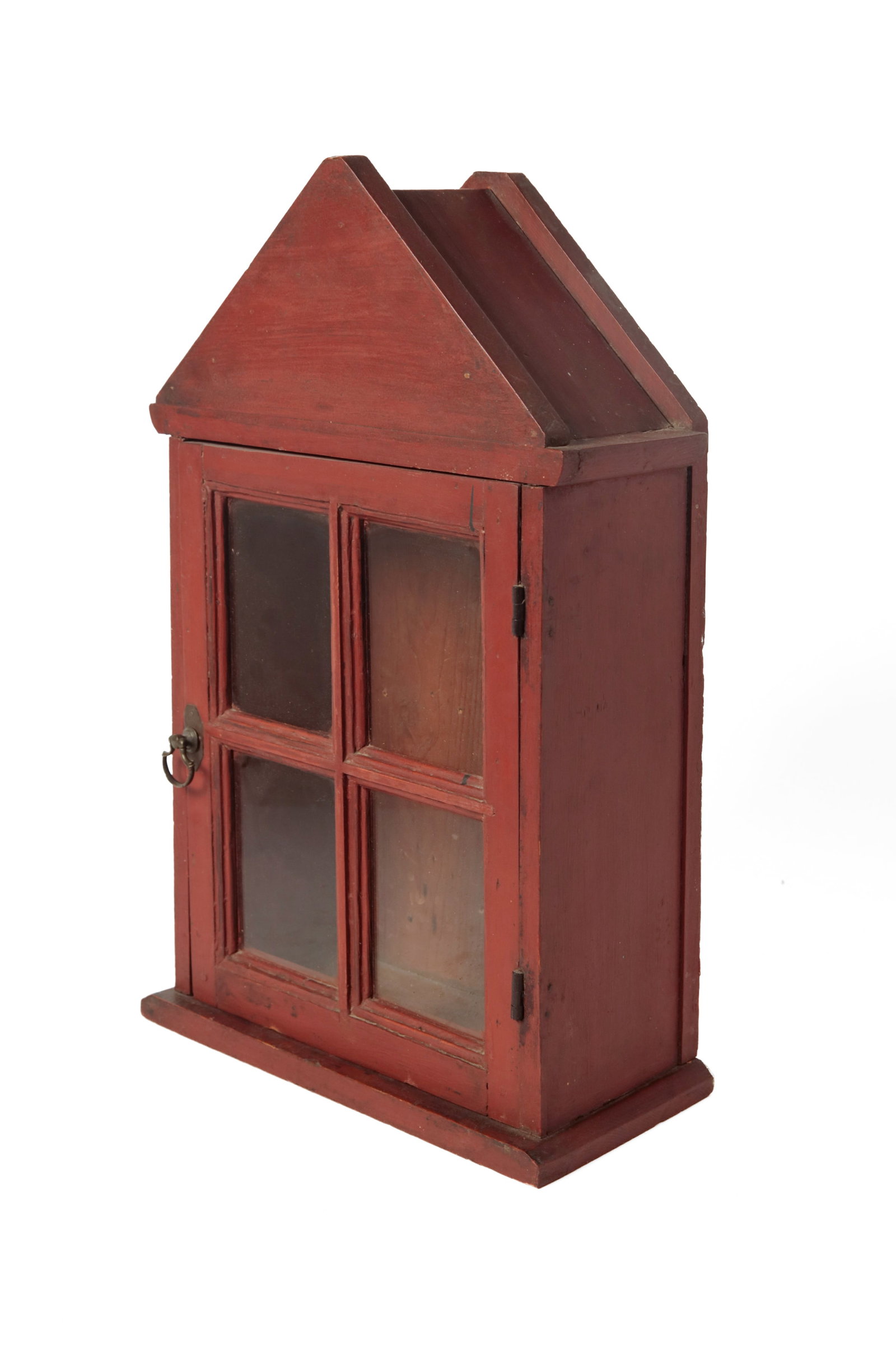 COUNTERTOP DISPLAY CABINET.: COUNTERTOP DISPLAY CABINET. American, 19th or early 20th Century. Pine. Simple nailed construction, peaked crest, four-pane door, and atop a simple base. In a brick red painted finish. 21.75"h.