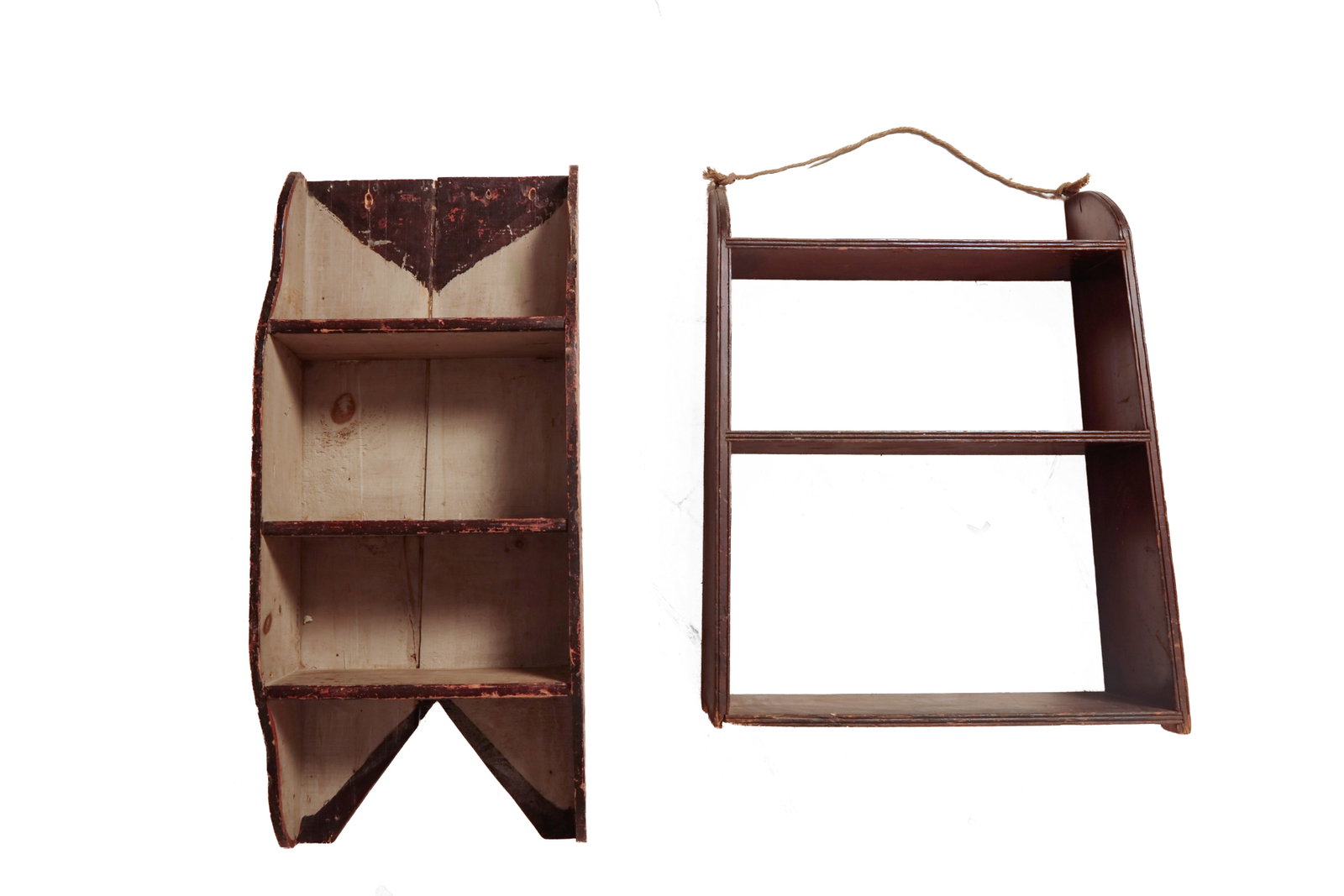 TWO SETS OF HANGING SHELVES.: TWO SETS OF HANGING SHELVES. American, 19th or 20th Century. A set with shaped ends, three routed edge shelves, and in a brown painted finish, 31"h. 23.5"w. 9"d. at base. Together with a set of