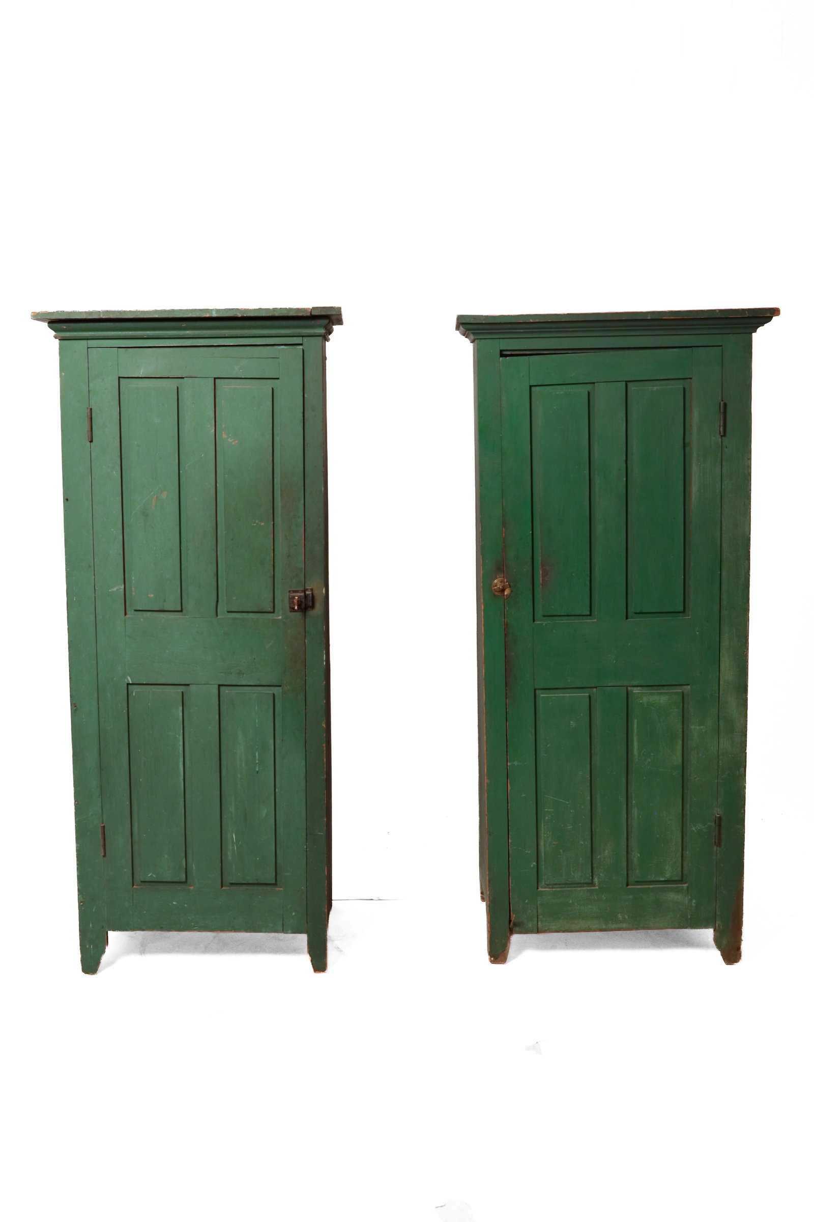 PAIR OF CHIMNEY CUPBOARDS WITH GREEN PAINT.: PAIR OF CHIMNEY CUPBOARDS WITH GREEN PAINT. American, mid- 19th Century. Pine. Applied cornice moldings, solid ends, single doors with four raised panels and simple cut-out feet. Old green repaint