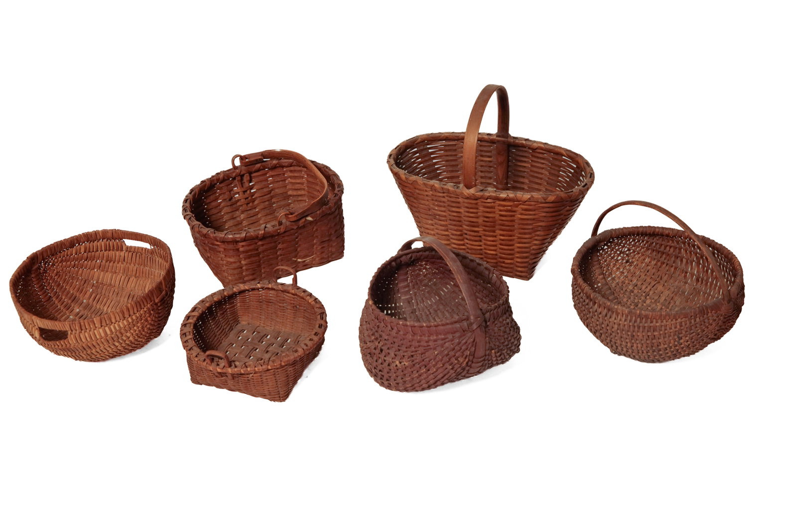 SIX SPLINT BASKETS.: SIX SPLINT BASKETS. American, late 19th and early 20th Century. Handled with rectangular bottom and lozenge-shaped top. 14"h. Two round-bottomed: one with dark finish. 10.75"h. The second with later
