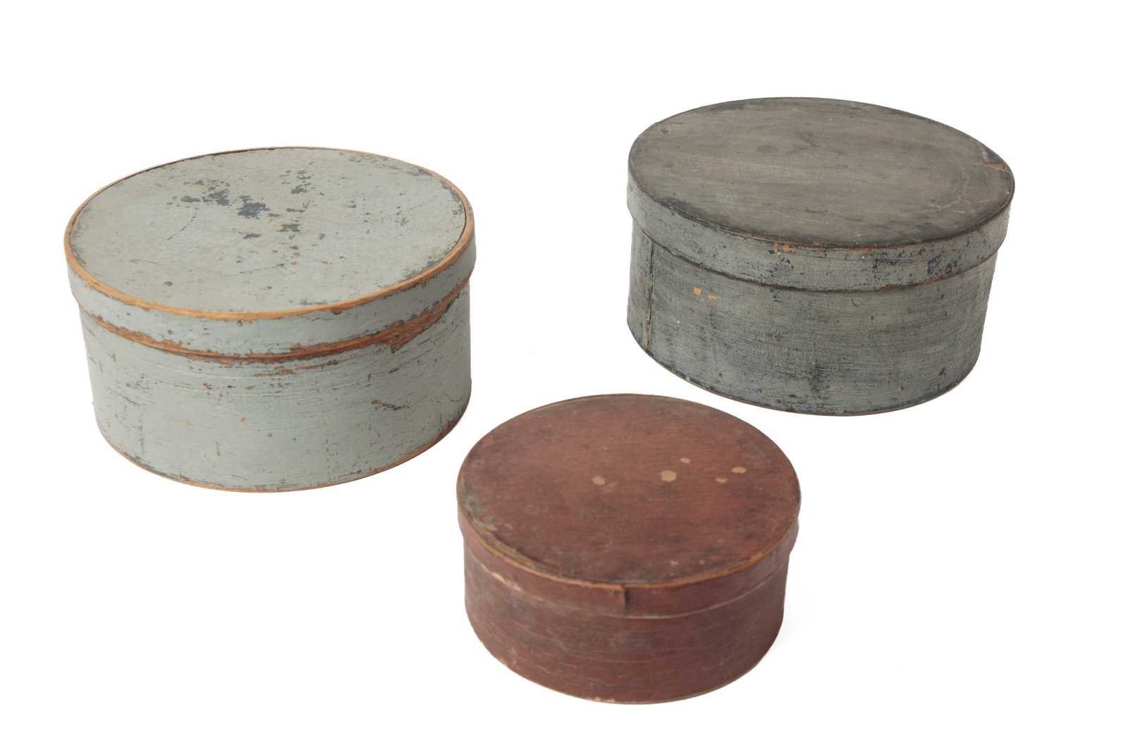 THREE PAINTED BENTWOOD PANTRY BOXES.: THREE PAINTED BENTWOOD PANTRY BOXES. American, 19th Century. Of circular form. Largest in alligatored bluish-gray paint, with lapped seams and iron tacks, 4,75"h. 10"d., the next in worn, light blue