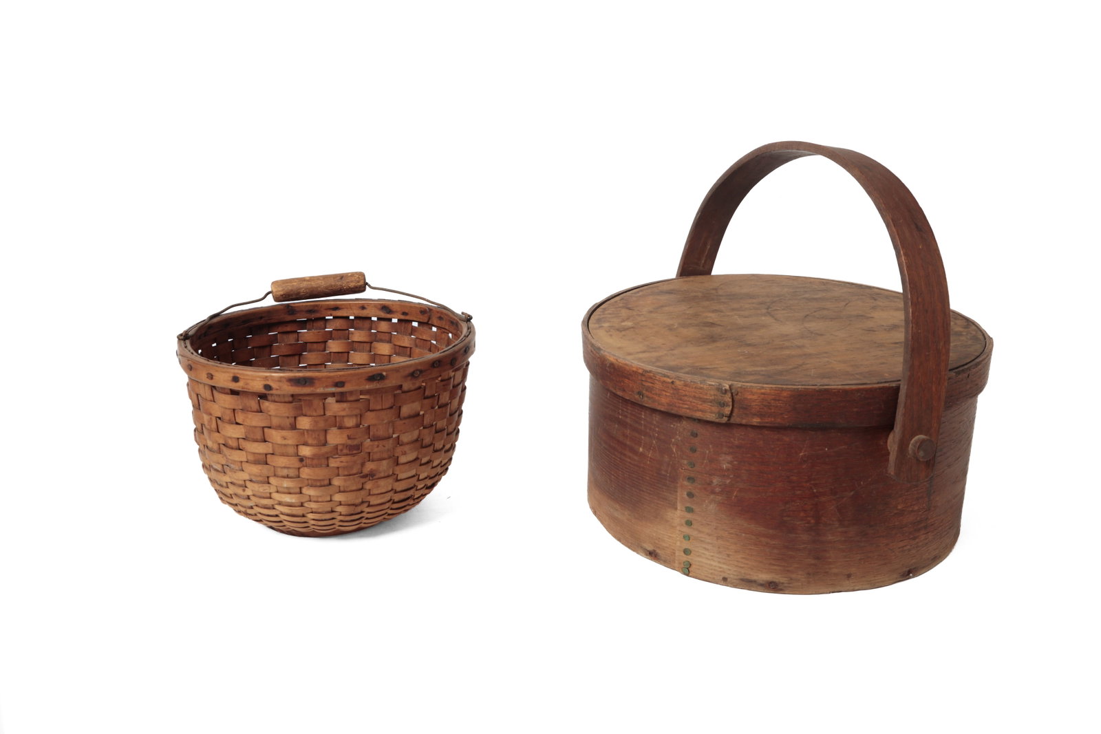 BENTWOOD CARRIER AND HANDLED WOVEN SPLINT BASKET.: BENTWOOD CARRIER AND HANDLED WOVEN SPLINT BASKET. American, 19th Century. A circular woven splint basket with a metal wire bale handle, 6.25"h., and a circular bentwood carrier, overlapping seams