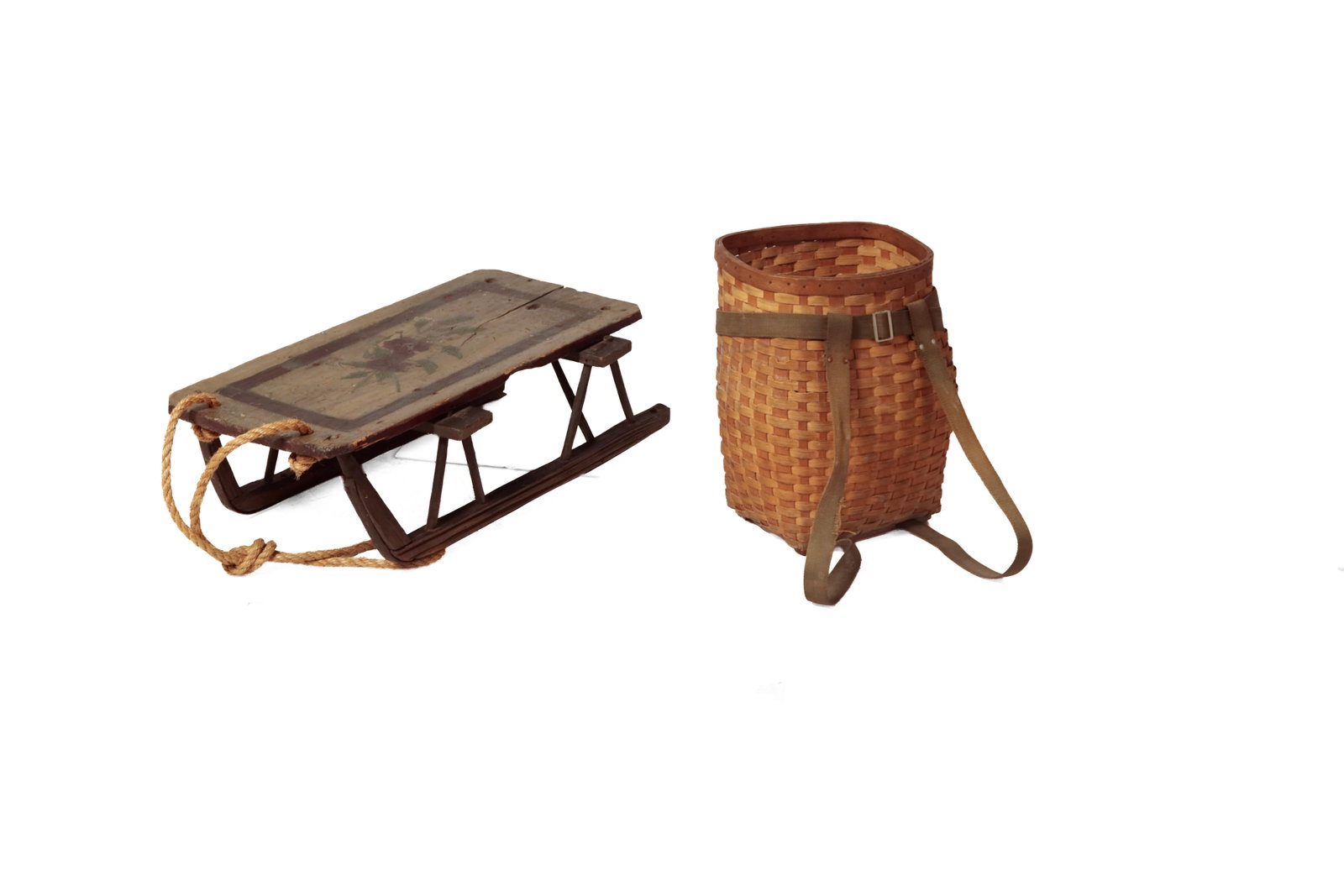 PAINT-DECORATED WOODEN SLED AND SPLINT CAMP BASKET.: PAINT-DECORATED WOODEN SLED AND SPLINT CAMP BASKET. American, 19th Century. Sled with rectangular seat with rounded corners, painted with red flowers and green leaves within a red border atop a gray g