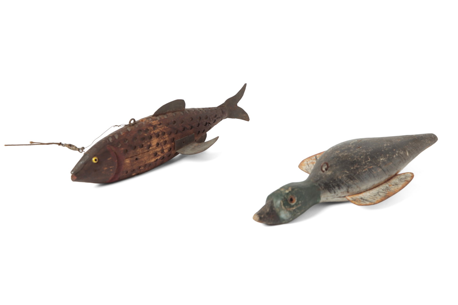 TWO FOLK ART CARVED AND PAINTED ICE FISHING DECOYS.: TWO FOLK ART CARVED AND PAINTED ICE FISHING DECOYS. American, 20th Century. A fish-form decoy with textured body, tin fins, glass eyes, and inset weights, 2.25"h. 8"l. Together with a painted duck dec