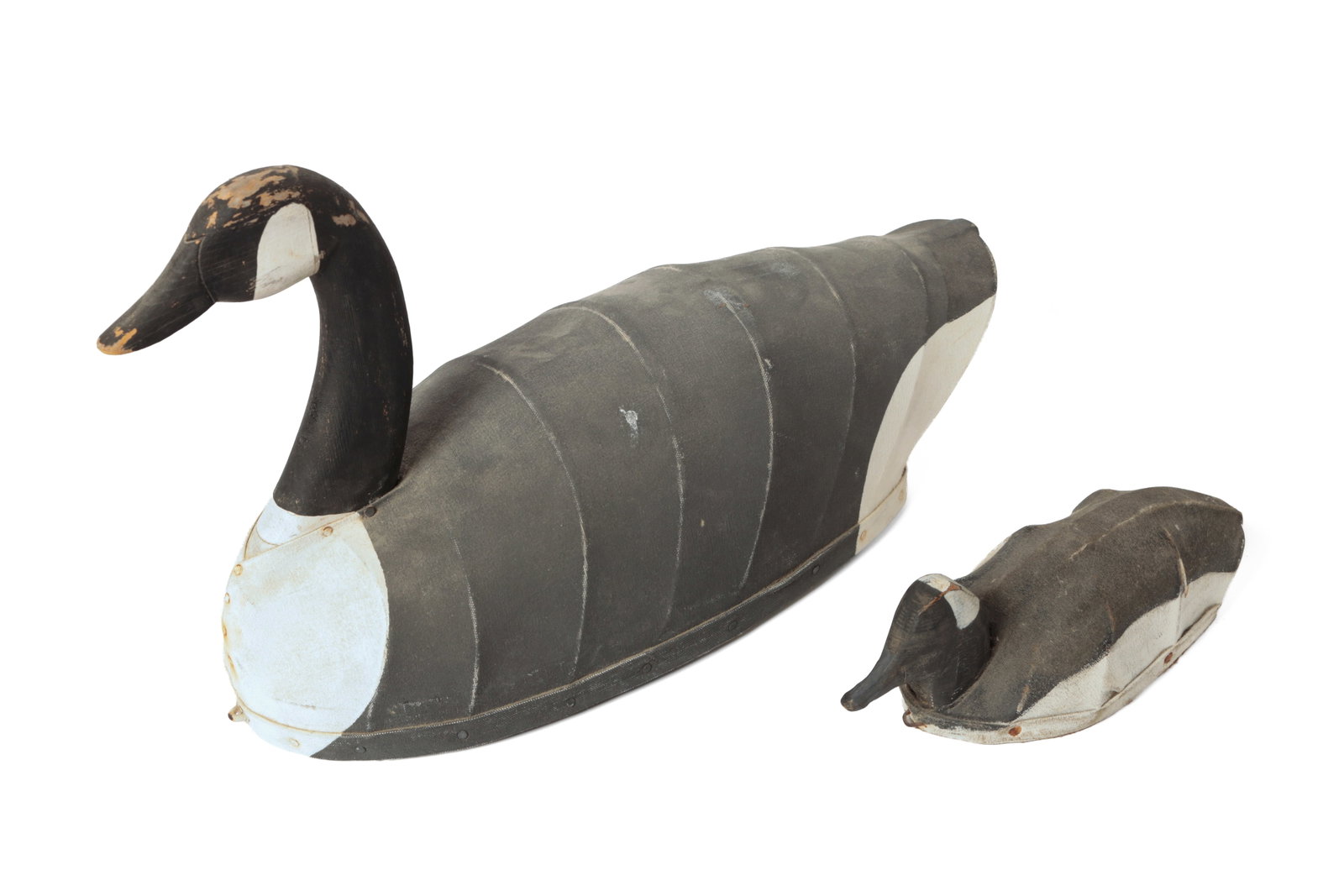 TWO CANVAS-OVER-WIRE DUCK AND GOOSE DECOYS.: TWO CANVAS-OVER-WIRE DUCK AND GOOSE DECOYS. American, 20th Century. Painted gray, black, and white, pine heads and bases; the larger is signed "D.B.H", 13"h. 22"l., and the smaller is signed