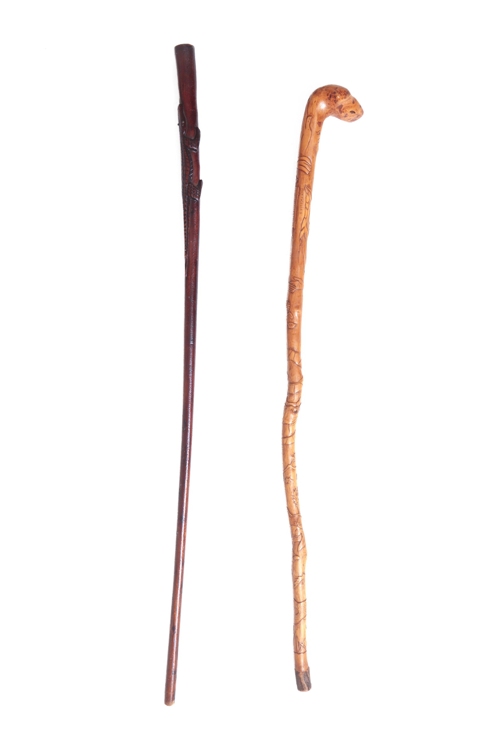 TWO FOLKSY ANIMAL MOTIF CARVED CANES.: TWO FOLKSY ANIMAL MOTIF CARVED CANES. American, 20th Century. A plain stick with a carved alligator near the top with alligatored paint, 38.5"l. Together with a Roscoe, Ohio, heavily carved cane