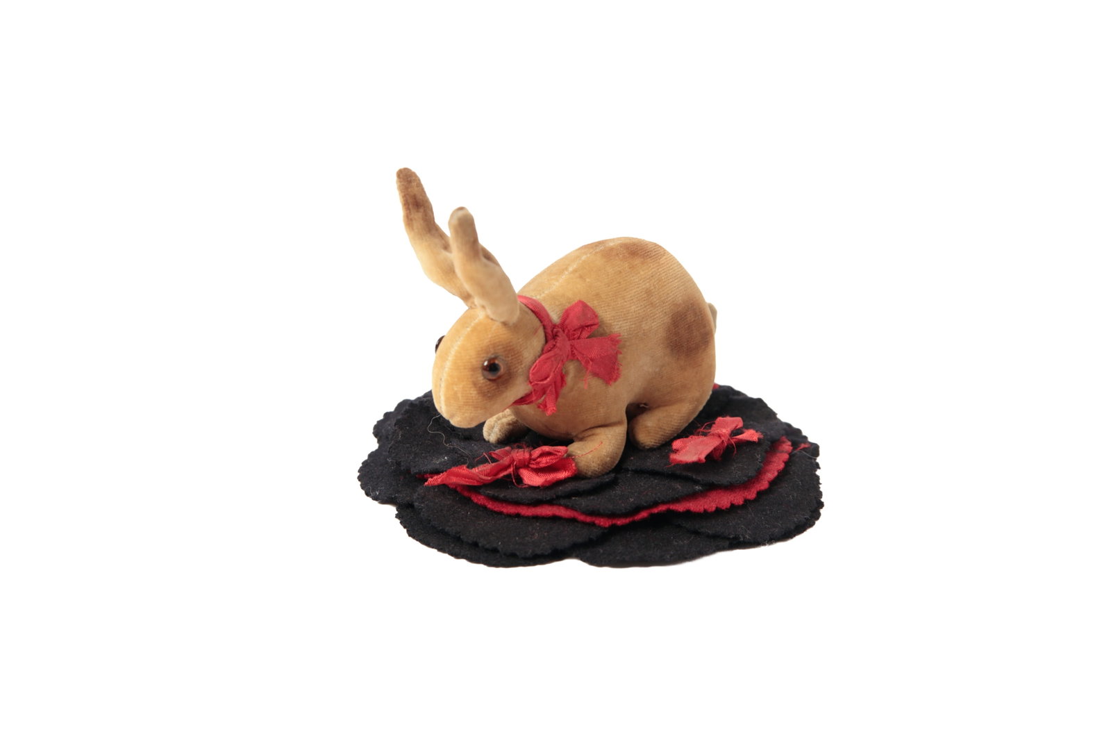 LARGE VELVETEEN RABBIT PENWIPE.: LARGE VELVETEEN RABBIT PENWIPE. American, late 19th or early 20th Century. Black and red layered circular felt base with pinked edge and a large tan rabbit with glass eyes and a red ribbon sewn to