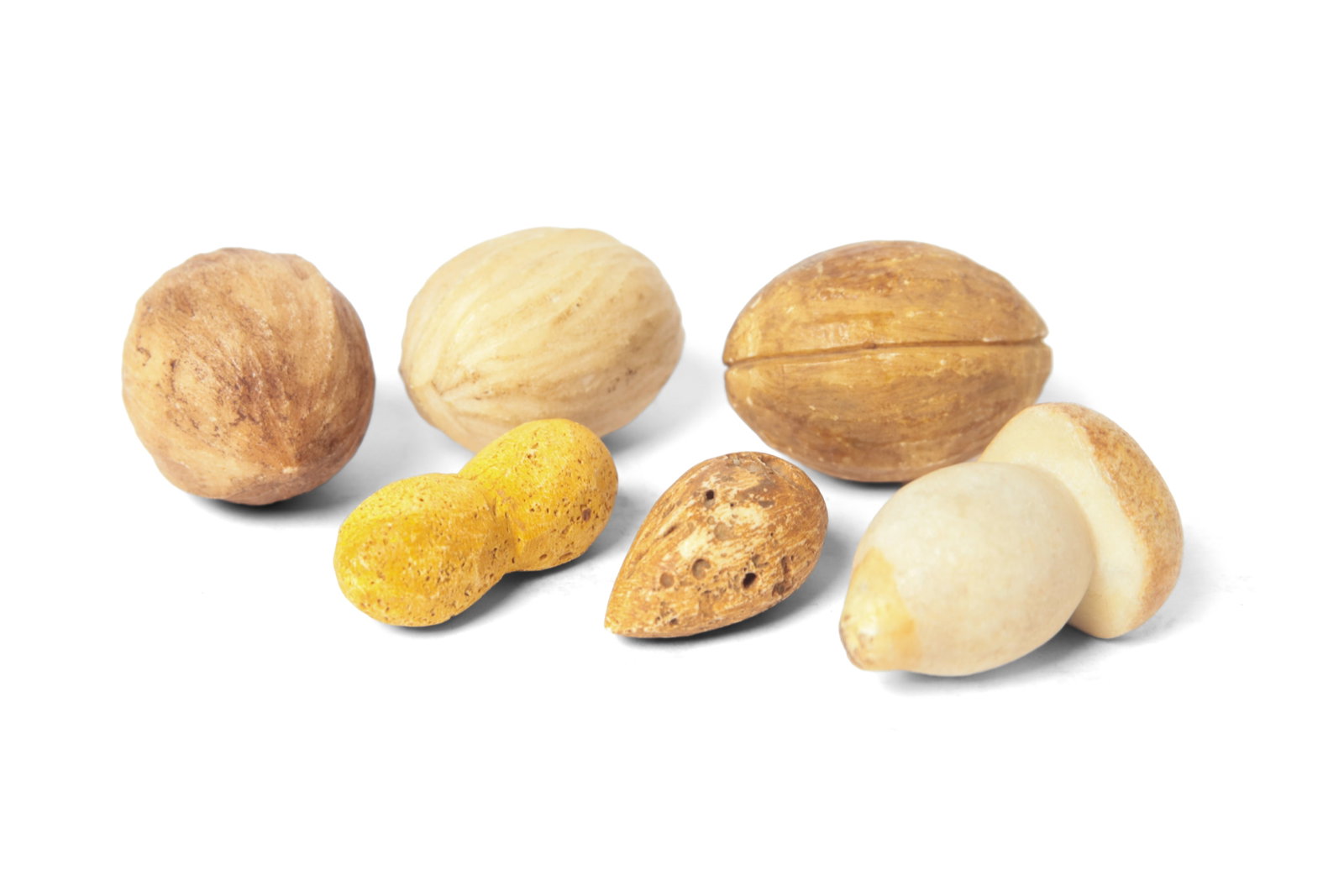 GROUP OF MINIATURE STONE NUTS AND A MUSHROOM.: GROUP OF MINIATURE STONE NUTS AND A MUSHROOM. American or European, late 19th or 20th Century. Includes a peanut, an almond, three walnuts and a shiitake mushroom. Largest, 2"l. Provenance: Nancy