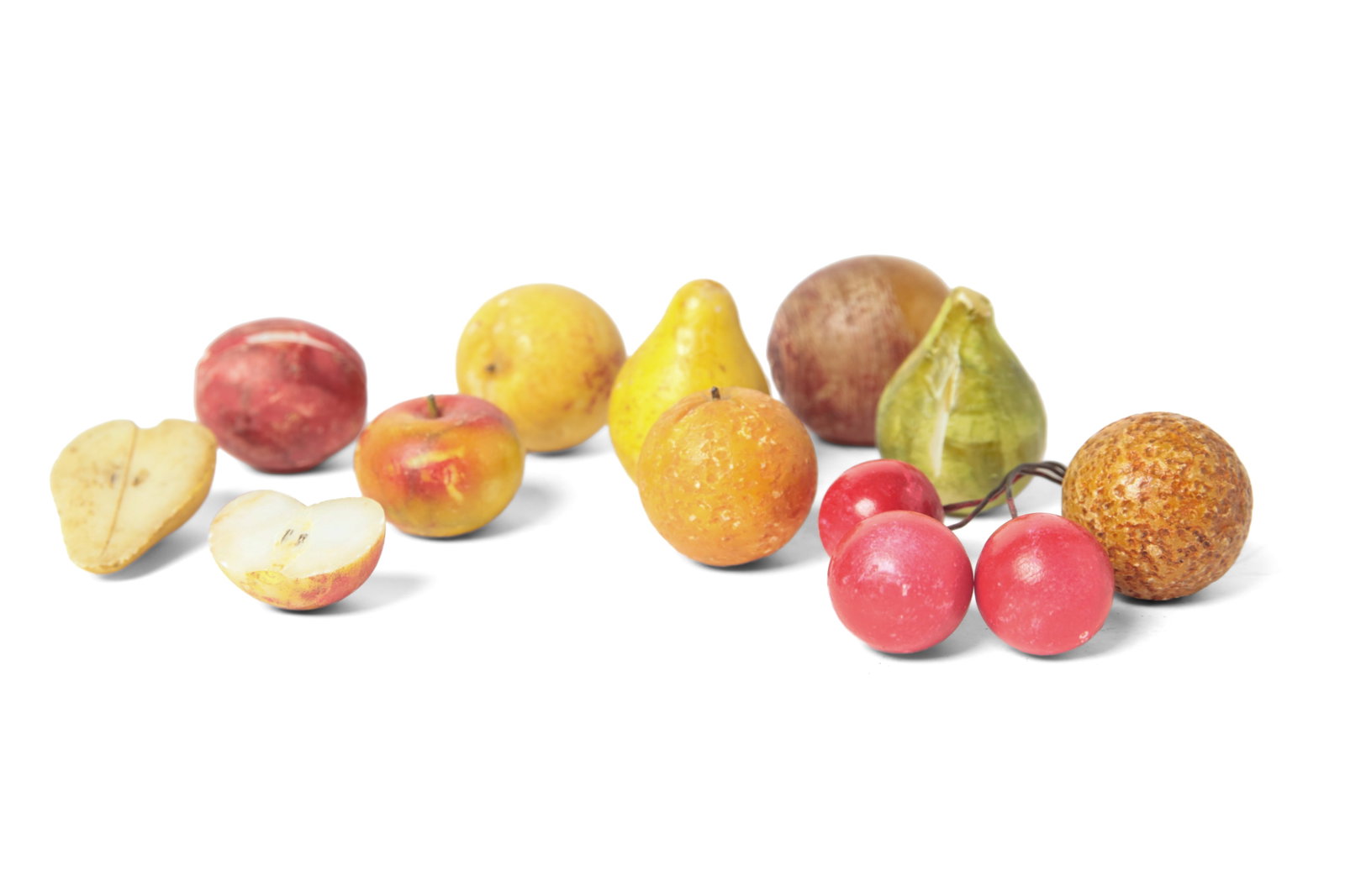 ELEVEN PIECES OF MINIATURE STONE FRUIT.: ELEVEN PIECES OF MINIATURE STONE FRUIT. American or European, late 19th or 20th Century. A pear, two oranges, a peach, a group of cherries, a fig, a plum, an apple, a beet, half a pear and half an app