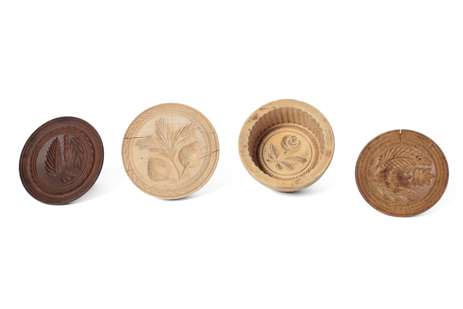 FOUR CARVED BUTTER PRINTS.: FOUR CARVED BUTTER PRINTS. American, 19th and early 20th Century. Carved round stamps with handles, comprising a double strawberry with leaves, a rose with fluted sides, a flower with leaves, and a