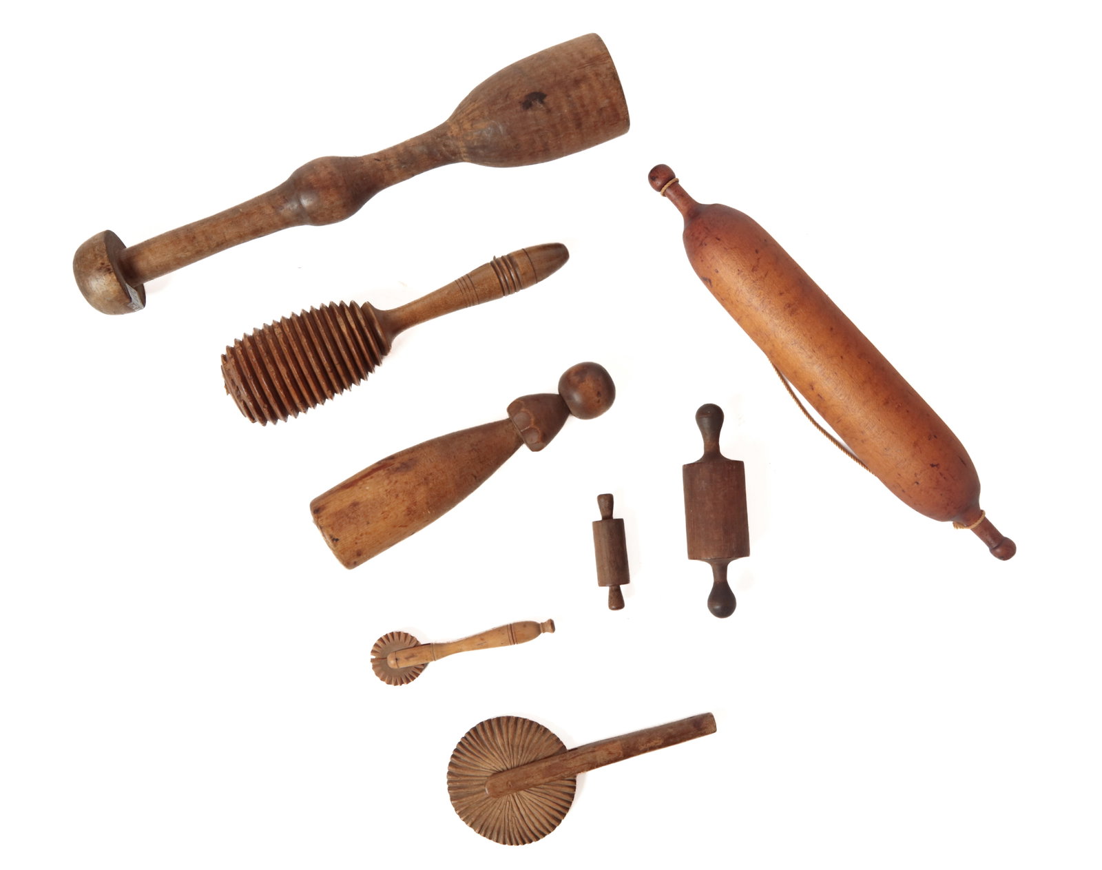 GROUP OF WOOD UTENSILS.: GROUP OF WOOD UTENSILS. American, 19th or 20th Century. Mixed woods. Includes a treen honey dipper, 10.5"h., two diminutive rolling pins, 3.25"l. and 6"l., two treenware pie crimpers, 5.5"l, and a lar