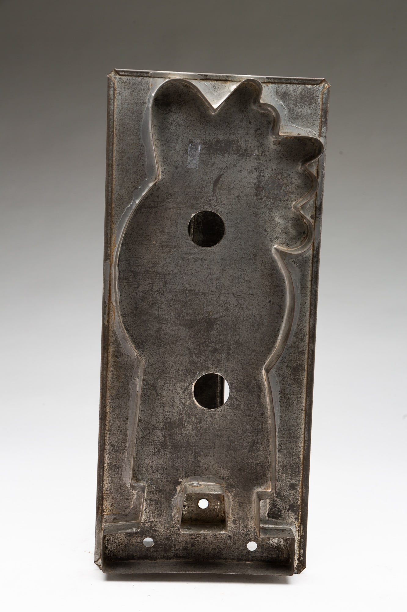 OVERSIZED BELSNICKEL COOKIE CUTTER.: OVERSIZED BELSNICKEL COOKIE CUTTER. American, 19th Century. Tinned sheet metal. Figural cutter depicting Belsnickel with a bag full of toys. Strap handle to back. 13.75"h. 6"w. Provenance: The Lifetim