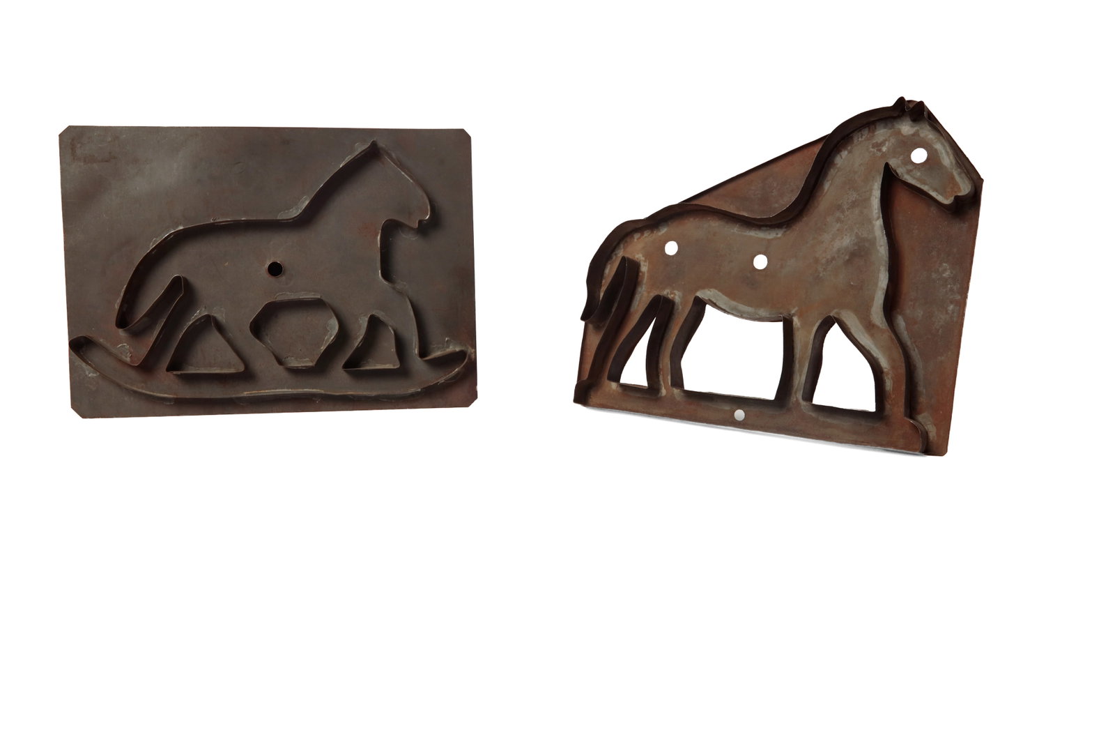 TWO LARGE TINNED SHEET METAL HORSE COOKIE CUTTERS.: TWO LARGE TINNED SHEET METAL HORSE COOKIE CUTTERS. American, 19th Century. A rocking horse cutter with a large flat back and attached strap handle, 10"h. 14.25"w., and a large horse cutter with a flat