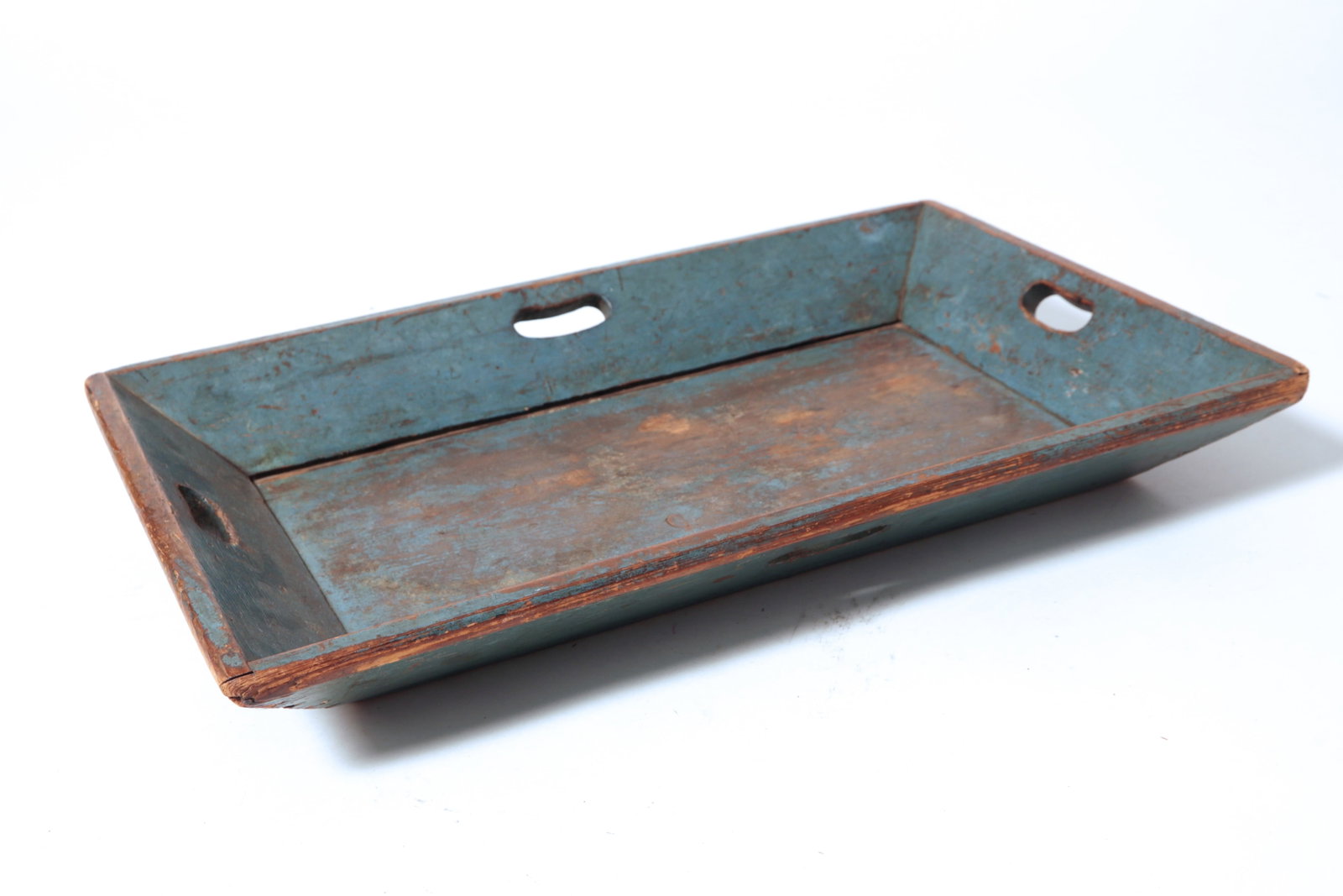 PINE APPLE TRAY IN ORIGINAL BLUE PAINT.: PINE APPLE TRAY IN ORIGINAL BLUE PAINT. American, 19th Century. Canted sides, cutout handles on four sides, and in blue paint. 3"h. 24"w. 16.25"d. Provenance: Nancy Goff (Alliance, Ohio); Sandy Hart