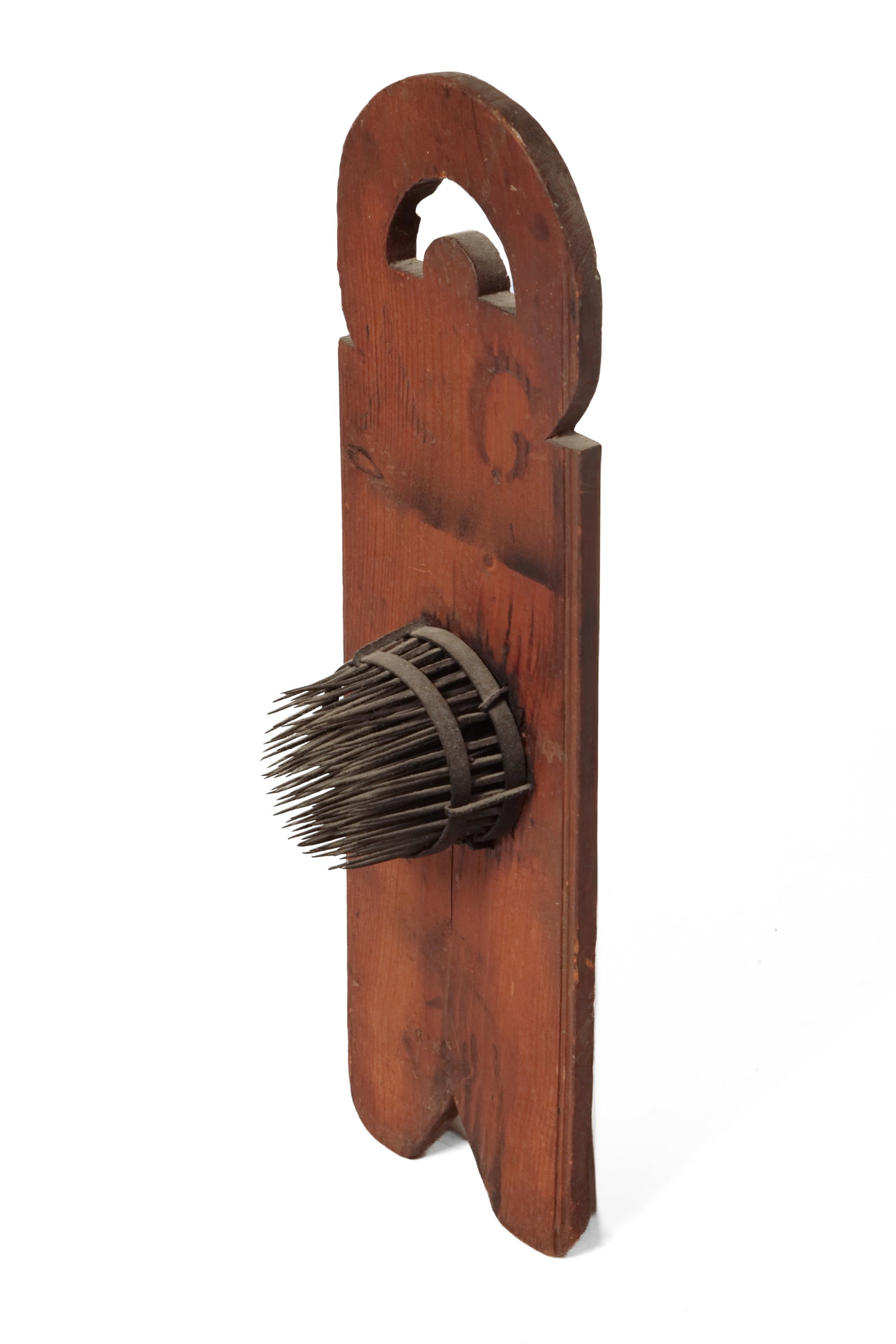 FORGED IRON HATCHEL ON A SHAPED PINE BACK.: FORGED IRON HATCHEL ON A SHAPED PINE BACK. American, first half 19th Century. Square spikes taper to sharp points, iron banding and spikes connecting to backboard with filed decoration board with