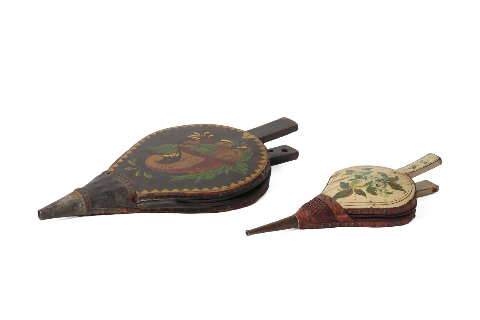 TWO PAINT-DECORATED BELLOWS.: TWO PAINT-DECORATED BELLOWS. American, 19th Century. One with a white-painted ground filled with blue and green flowers, with a brass nozzle and leather trim, 17"I., and the larger with a black