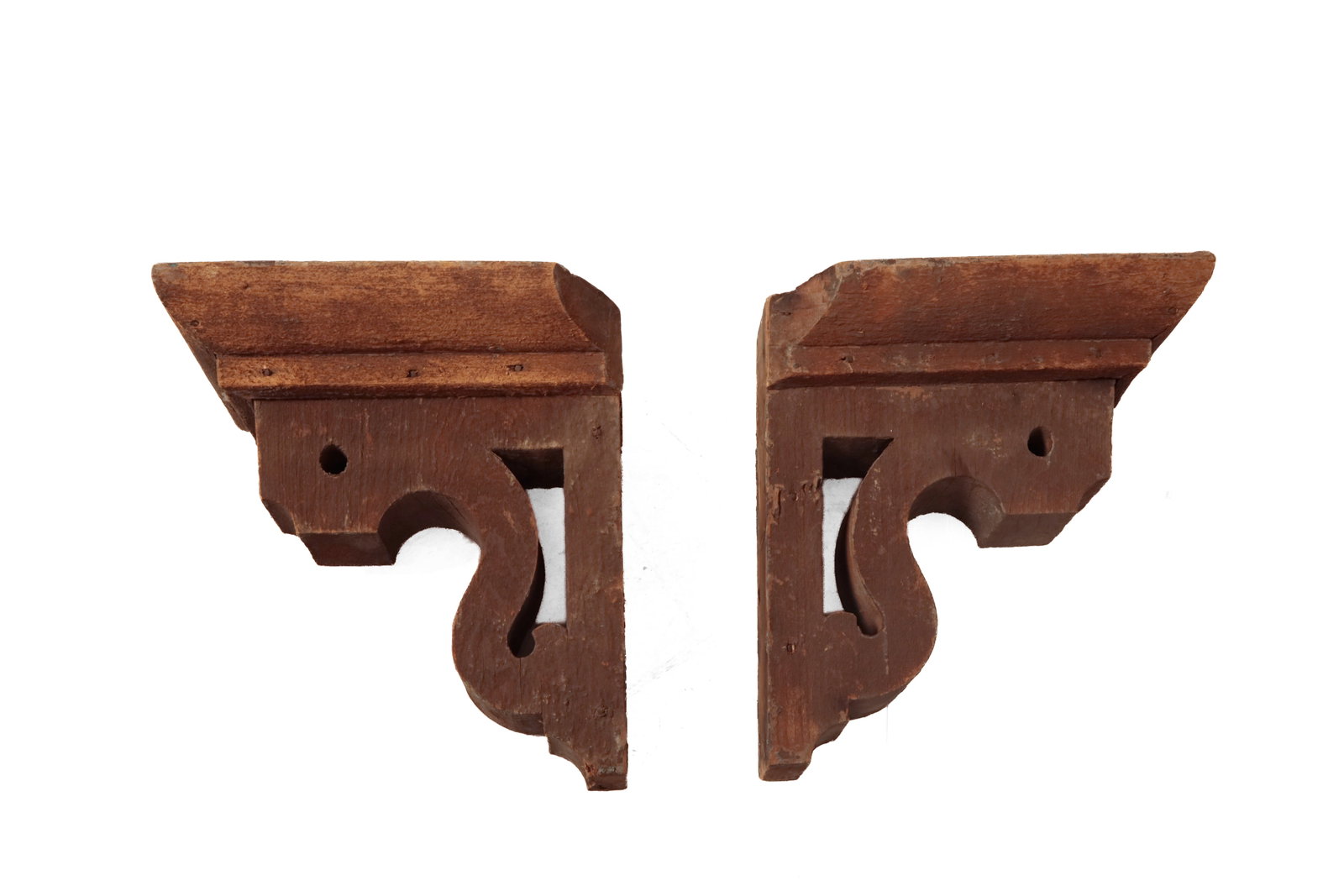PAIR OF PIERCED AND SCROLL-CUT ARCHITECTURAL GABLE BRACKETS WITH ORIGINAL PAINT.: PAIR OF PIERCED AND SCROLL-CUT ARCHITECTURAL GABLE BRACKETS WITH ORIGINAL PAINT. American, 19th Century. Pine. Having square nail construction with convex cornice molding over cut and pierced