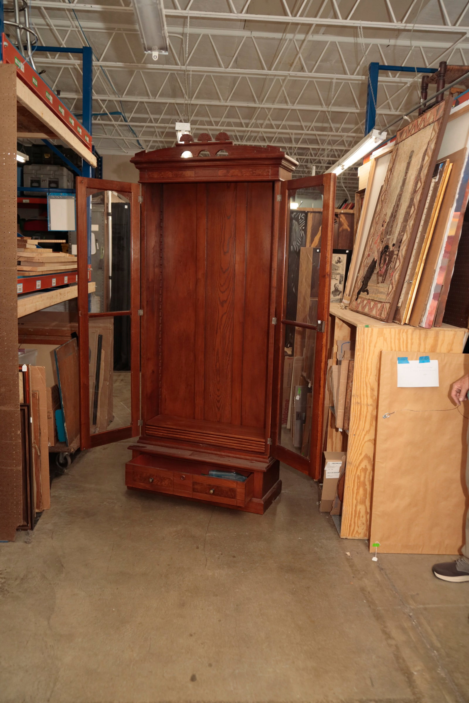 EASTLAKE VICTORIAN BOOKCASE.: EASTLAKE VICTORIAN BOOKCASE. American, fourth quarter 19th Century. Walnut with poplar and oak secondary. In two pieces. Top with jigsaw cut and line carved pediment, applied cornice moldings, two