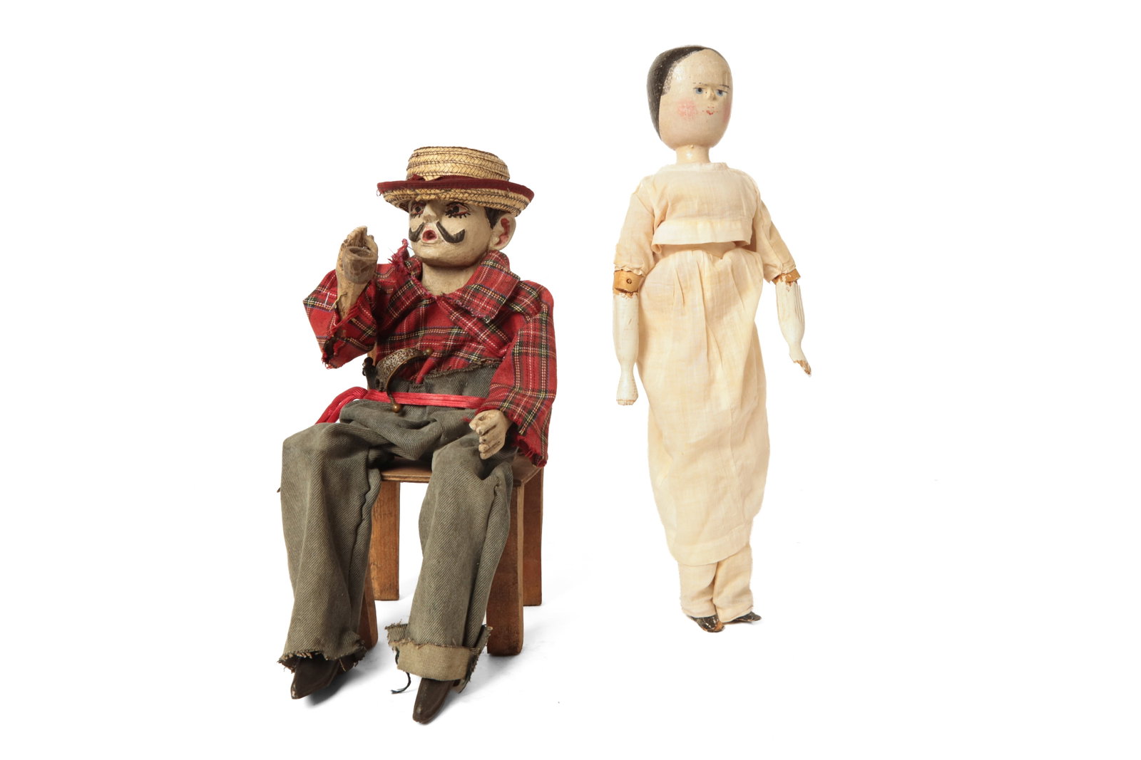GUATEMALAN ARTICULATED, CARVED, AND PAINTED WOOD SAN SIMON FIGURE IN CHAIR AND EUROPEAN GRODNERTAL: GUATEMALAN ARTICULATED, CARVED, AND PAINTED WOOD SAN SIMON FIGURE IN CHAIR AND EUROPEAN GRODNERTAL PEG DOLL. 20th Century. Figure seated in a simple wood chair; with painted face and body wearing a