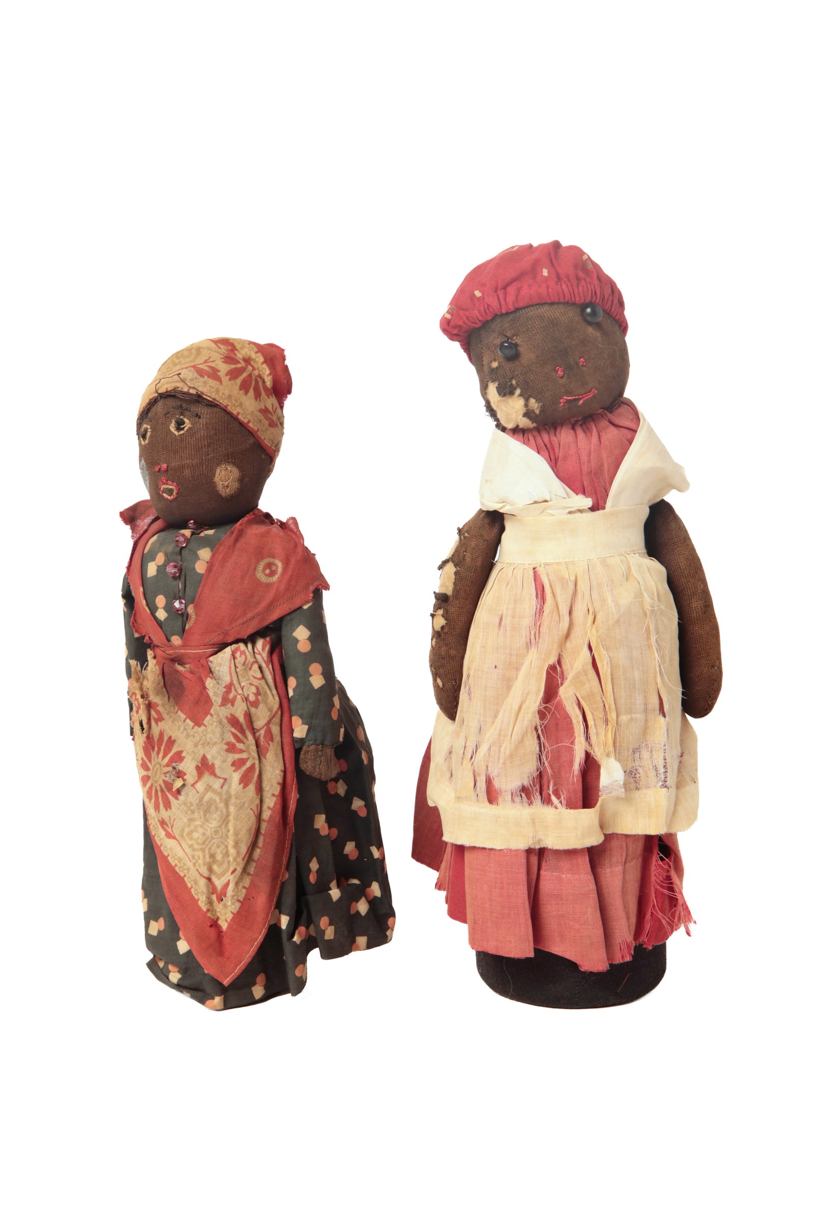 TWO FOLK ART BLACK AMERICANA BOTTLE DOLLS.: TWO FOLK ART BLACK AMERICANA BOTTLE DOLLS. American, late 19th or early 20th Century. Both made of stuffed brown and black cloth mounted to a weighted glass bottle. One with button eyes, stitched