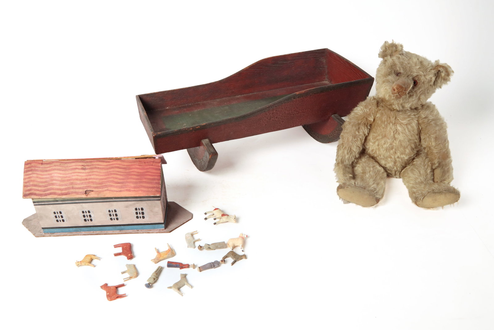 THREE CHILD'S TOYS.: THREE CHILD'S TOYS. American, second half 19th and early 20th Century. Noah's Ark, original paint with a dozen or so painted animals 7.25"h. 16"l., a pine doll cradle with original rust red paint and