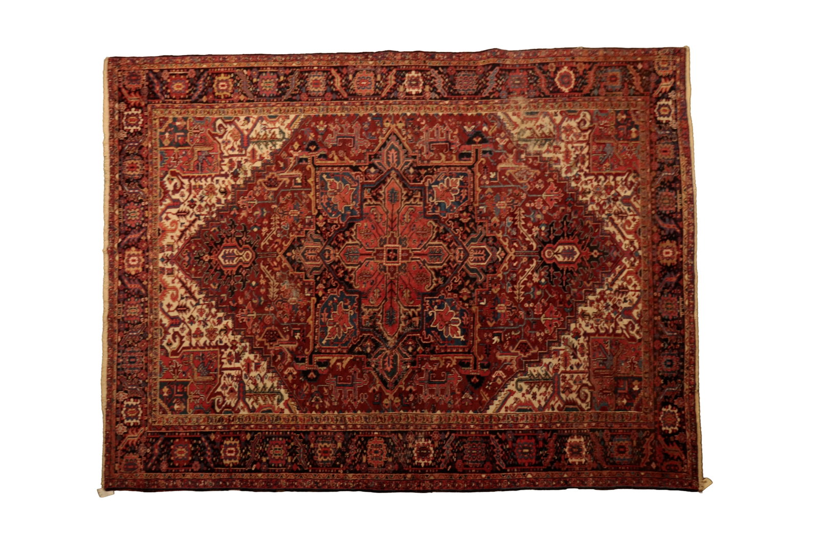 HERIZ ROOM SIZE RUG.: HERIZ ROOM SIZE RUG. Persian, late 20th Century. Wool. Hand-knotted. Rust red field, coral and blue medallion, tan, coral and blue borders, and overall multi-colored geometric pattern. 114"w. 162"l. P